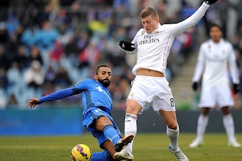 GETAFE, SPAIN - JANUARY 18:  Toni Kroos of Real Madrid is tackled by Diego Castro of Getafe CF during the La Liga match between Getafe CF and Real Madrid CF at Coliseum Alfonso Perez stadium on January 18, 2015 in Getafe, Spain.  (Photo by Denis Doyle/Get