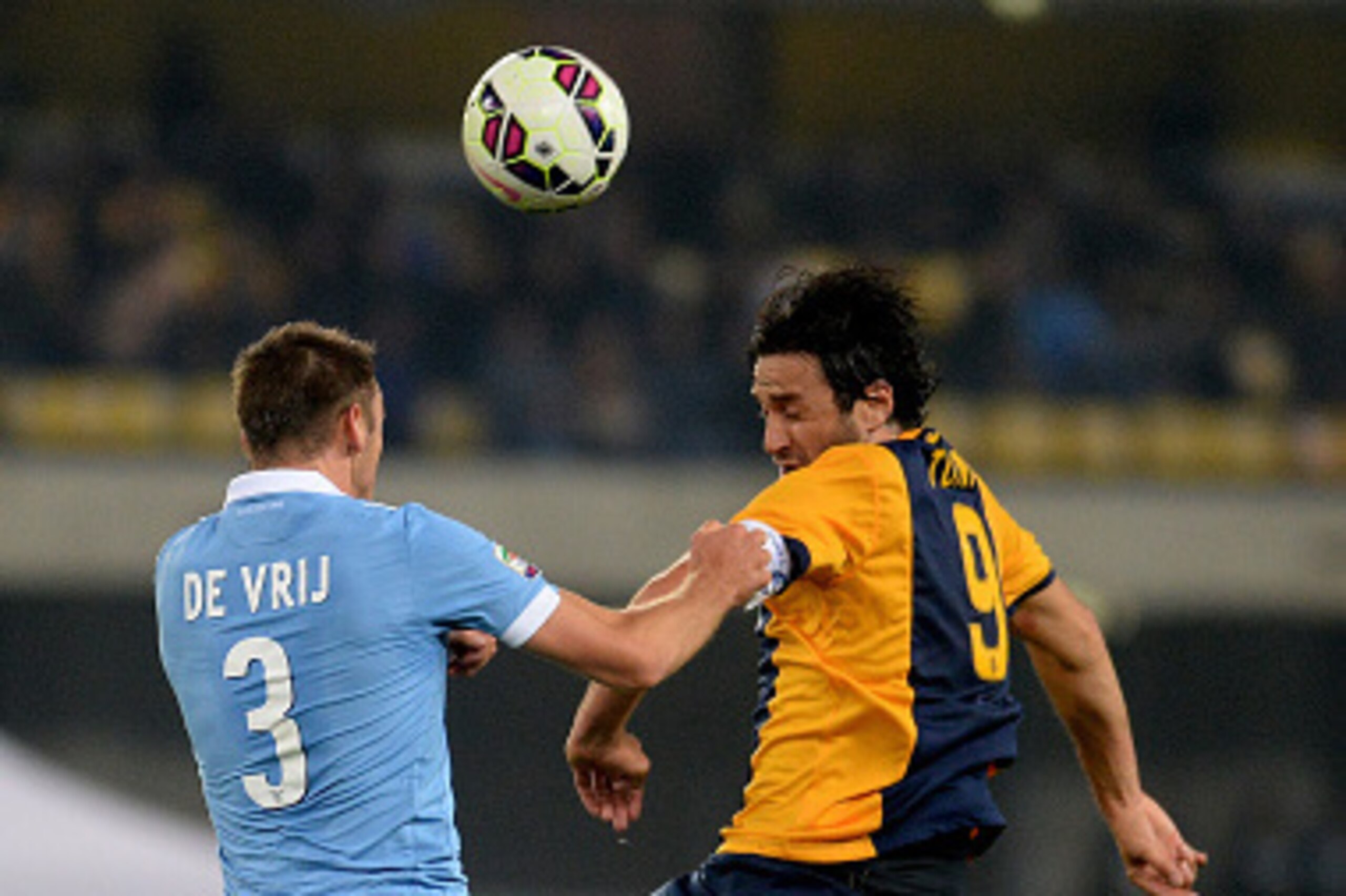 VERONA, ITALY - OCTOBER 30:  Luca Toni (L) of Lazio battles for an aerial ball with Stefan De Vrij of Hellas Verona during the Serie A match between Hellas Verona FC and SS Lazio at Stadio Marc'Antonio Bentegodi on October 30, 2014 in Verona, Italy.  (Pho