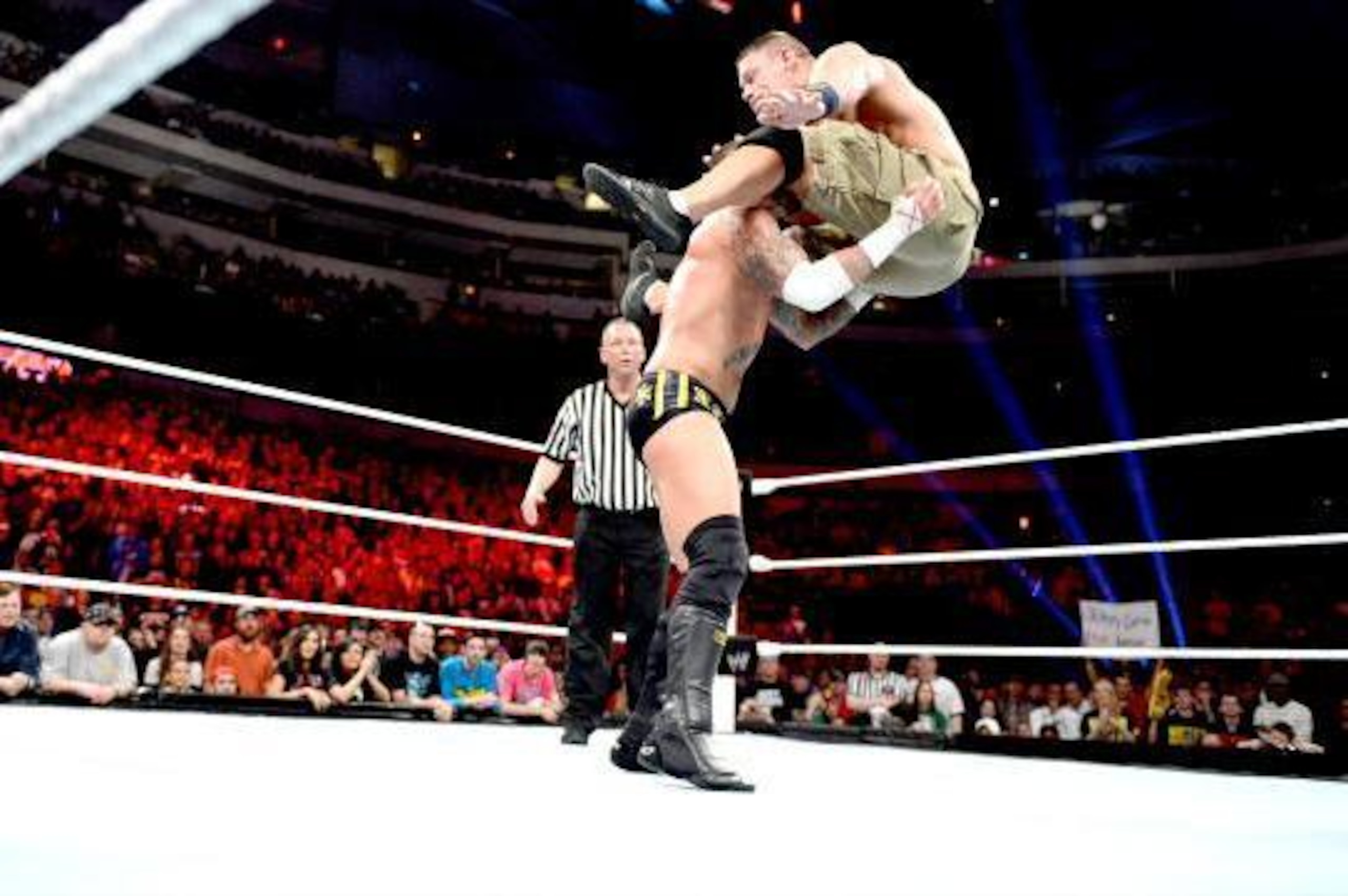 John Cena hits a hurricanrana on CM Punk in 2013.