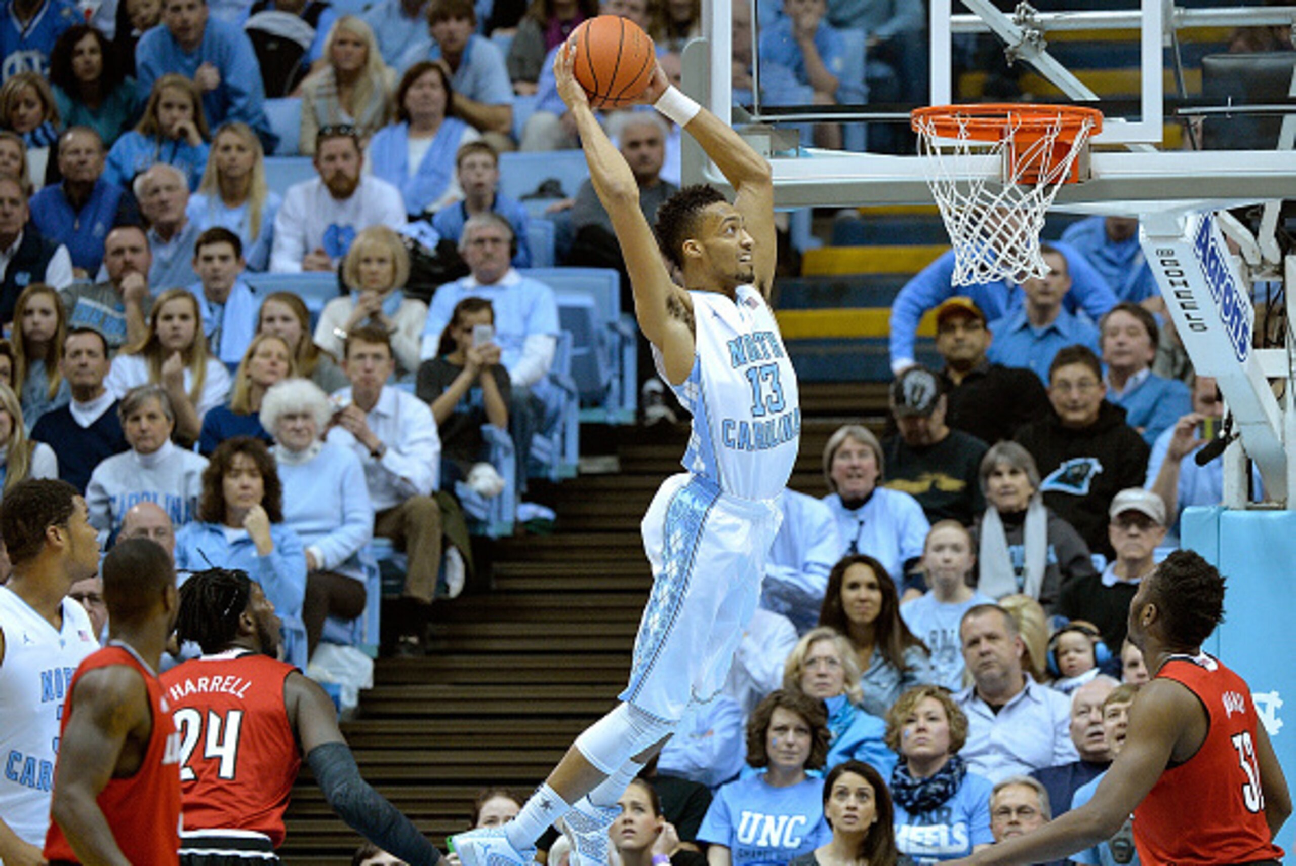 CHAPEL HILL, NC - JANUARY 10:  J.P. Tokoto #13 of the North Carolina Tar Heels drives in for a dunk against the Louisville Cardinals during their game at the Dean Smith Center on January 10, 2015 in Chapel Hill, North Carolina.  (Photo by Grant Halverson/