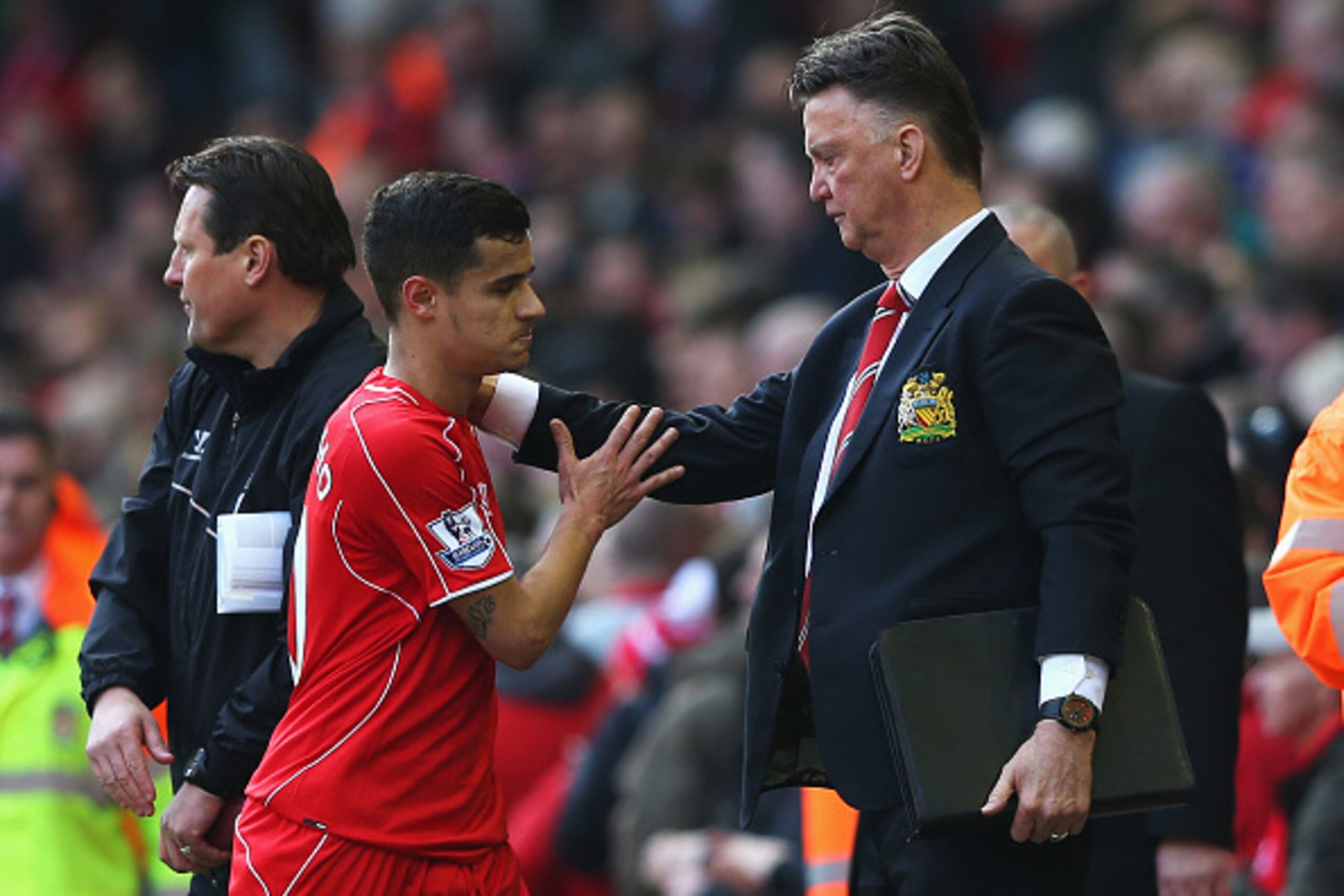 LIVERPOOL, ENGLAND - MARCH 22: Louis van Gaal, manager of Manchester United consoles Philippe Coutinho of Liverpool as he leaves the field after the Barclays Premier League match between Liverpool and Manchester United at Anfield on March 22, 2015 in Live