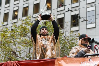 SAN FRANCISCO, CA - OCTOBER 31: World Series MVP Madison Bumgarner #40 of the San Francisco Giants, shows his MVP trophy to the crowd along the parade route during the San Francisco Giants World Series victory parade on October 31, 2014 in San Francisco, 