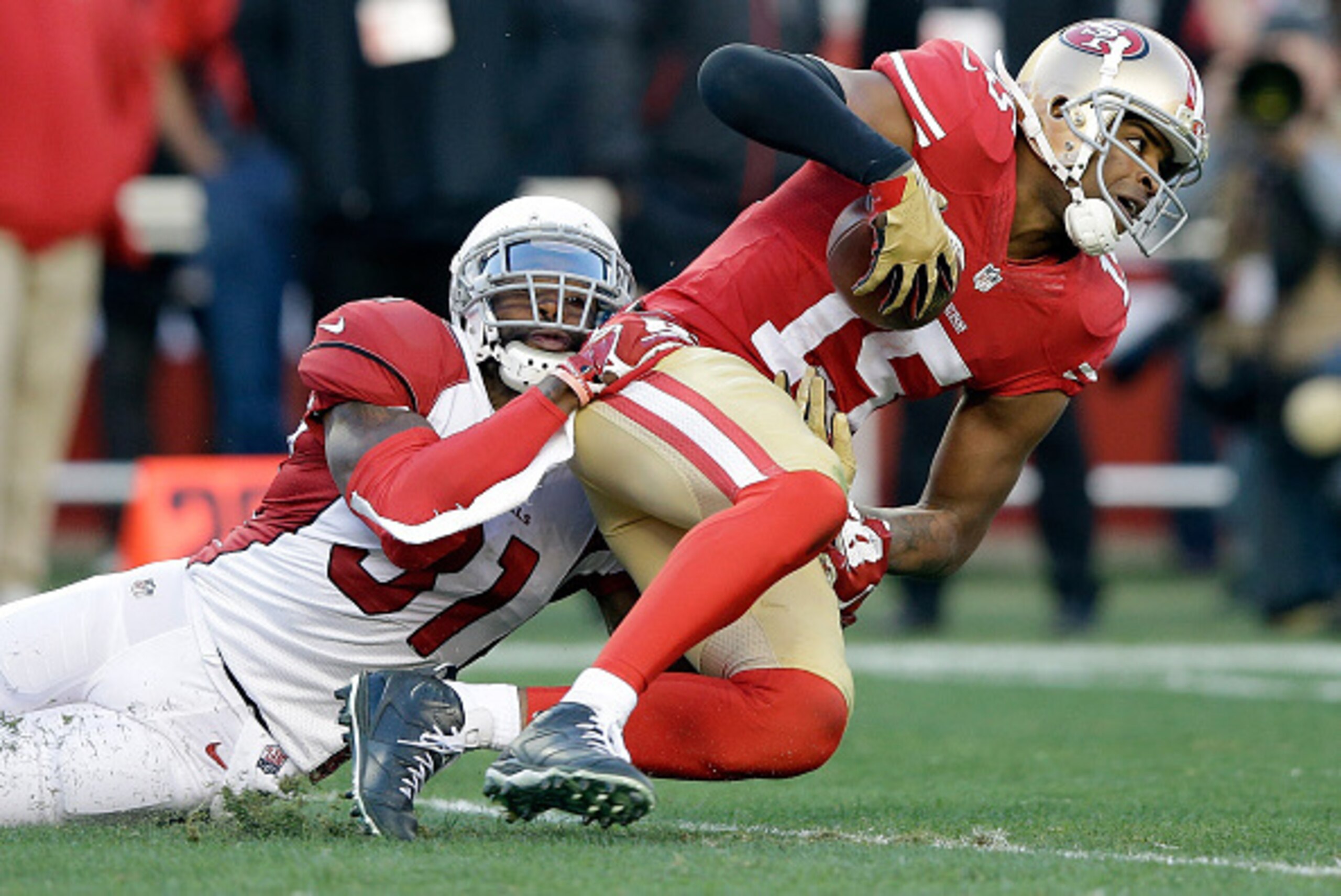 SANTA CLARA, CA - DECEMBER 28:  Michael Crabtree #15 of the San Francisco 49ers is tackled by Antonio Cromartie #31 of the Arizona Cardinals at Levi's Stadium on December 28, 2014 in Santa Clara, California.  (Photo by Ezra Shaw/Getty Images)