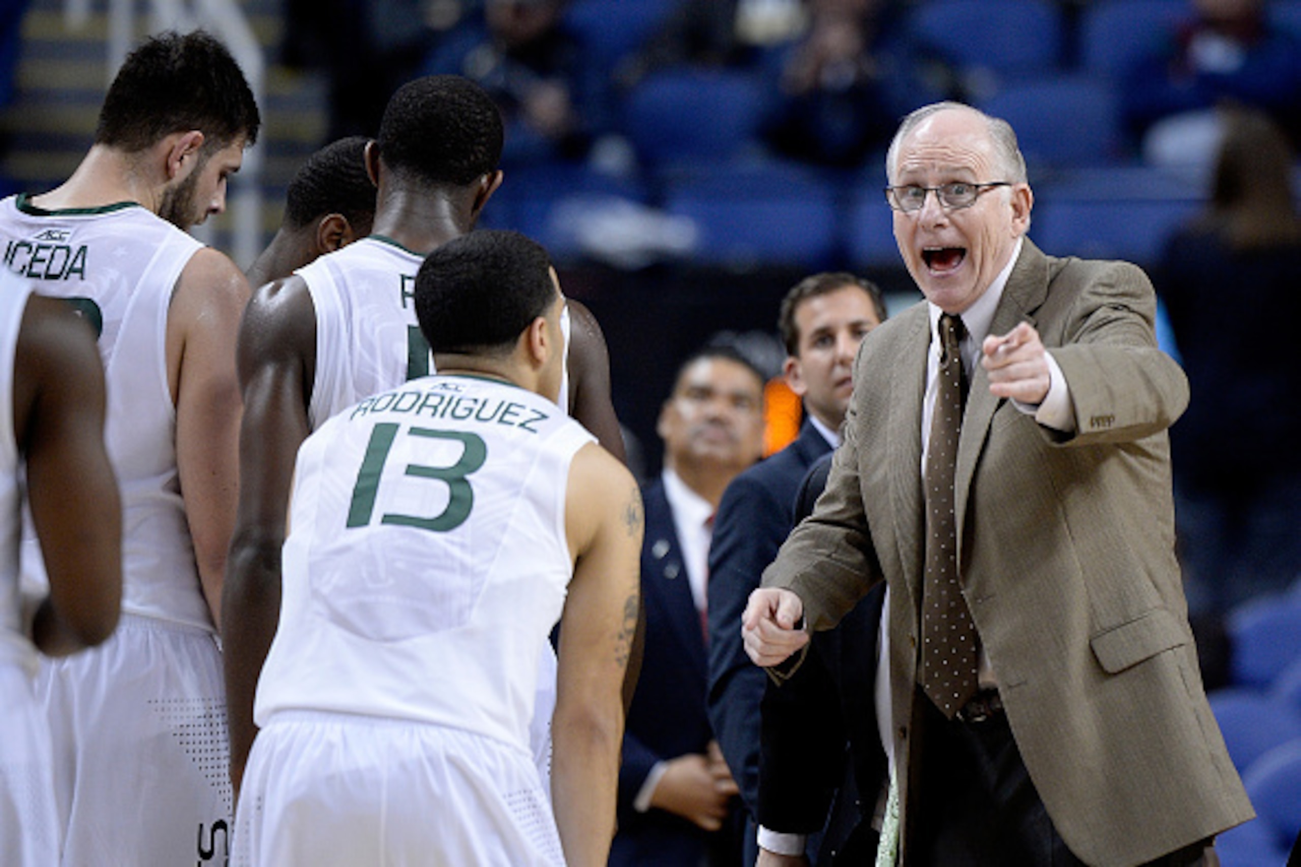 GREENSBORO, NC - MARCH 11:  Head coach Jim Larranaga of the Miami Hurricanes huddles with his team during a gme against the Virginia Tech Hokies during a second round game of the ACC basketball tournament at Greensboro Coliseum on March 11, 2015 in Greens