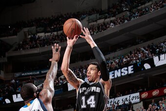 DALLAS, TX - MARCH 24: Danny Green #14 of the San Antonio Spurs shoots a jumper against Amare Stoudemire #1 of the Dallas Mavericks on March 24, 2015 at the American Airlines Center in Dallas, Texas. NOTE TO USER: User expressly acknowledges and agrees th