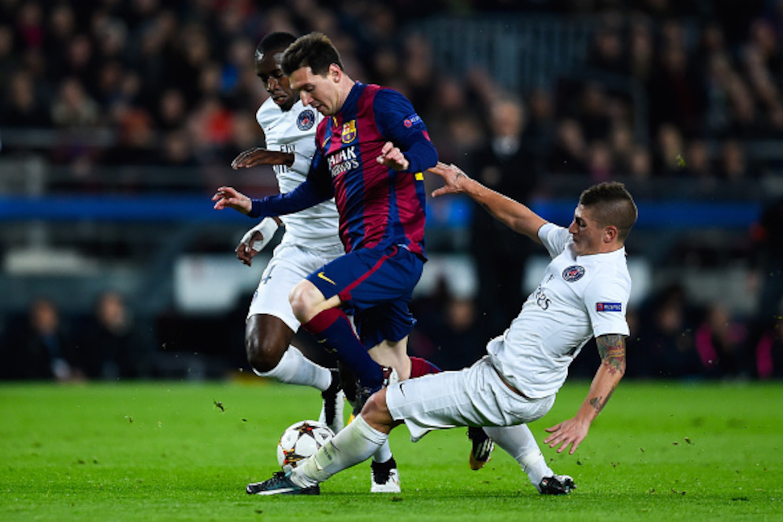 BARCELONA, SPAIN - DECEMBER 10: Lionel Messi of FC Barcelona competes for the ball with Blaise Matuidi (L) and Marco Verratti of Paris Saint-Germain FC during his team's first goal of FC Barcelona during the UEFA Champions League group F match between F BARCELONA, SPAIN - DECEMBER 10: Lionel Messi of FC Barcelona competes for the ball with Blaise Matuidi (L) and Marco Verratti of Paris Saint-Germain FC during his team's first goal of FC Barcelona during the UEFA Champions League group F match between F