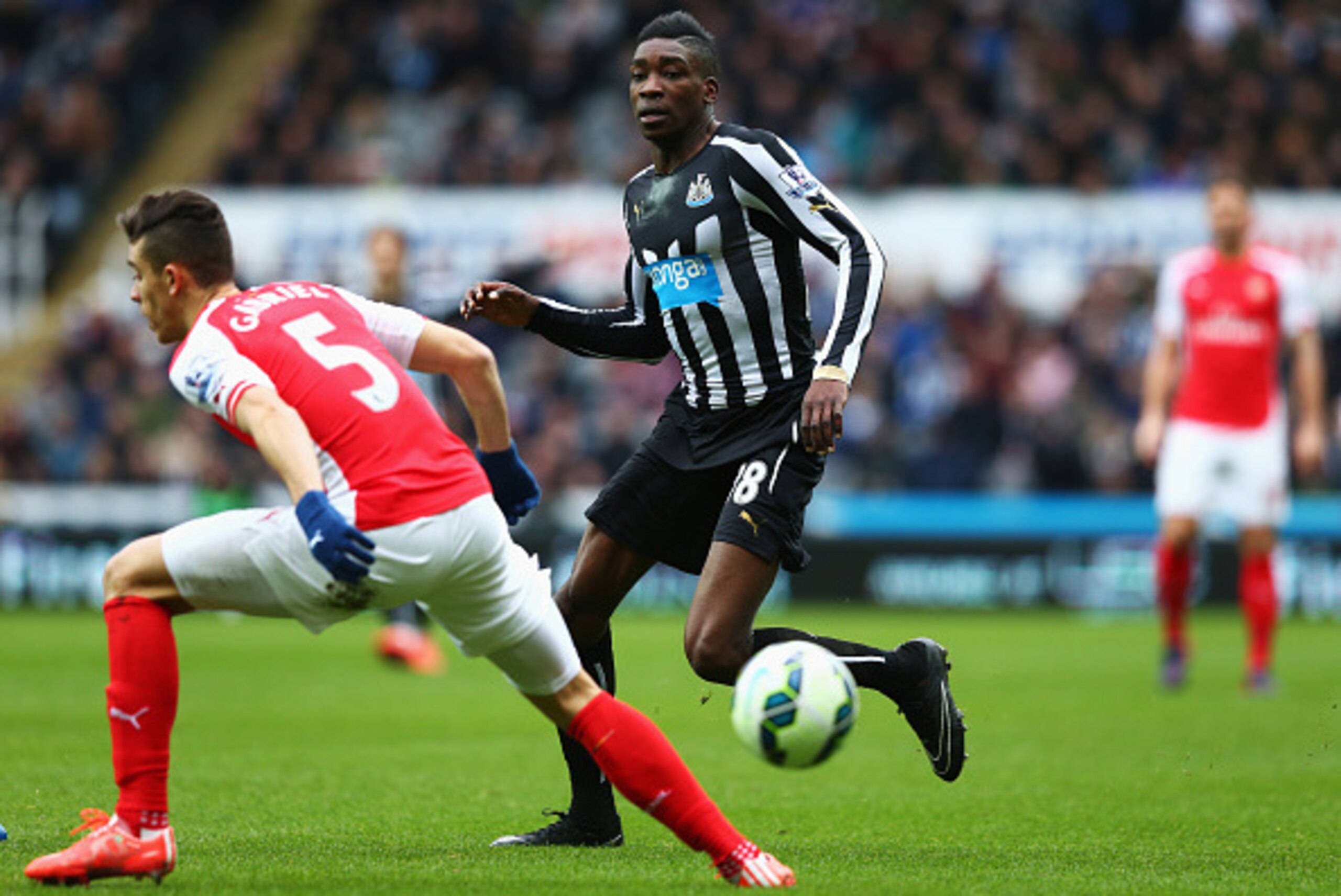 NEWCASTLE UPON TYNE, ENGLAND - MARCH 21: Sammy Ameobi of Newcastle United goes past Gabriel Paulista of Arsenal during the Barclays Premier League match between Newcastle United and Arsenal at St James' Park on March 21, 2015 in Newcastle upon Tyne, Engla