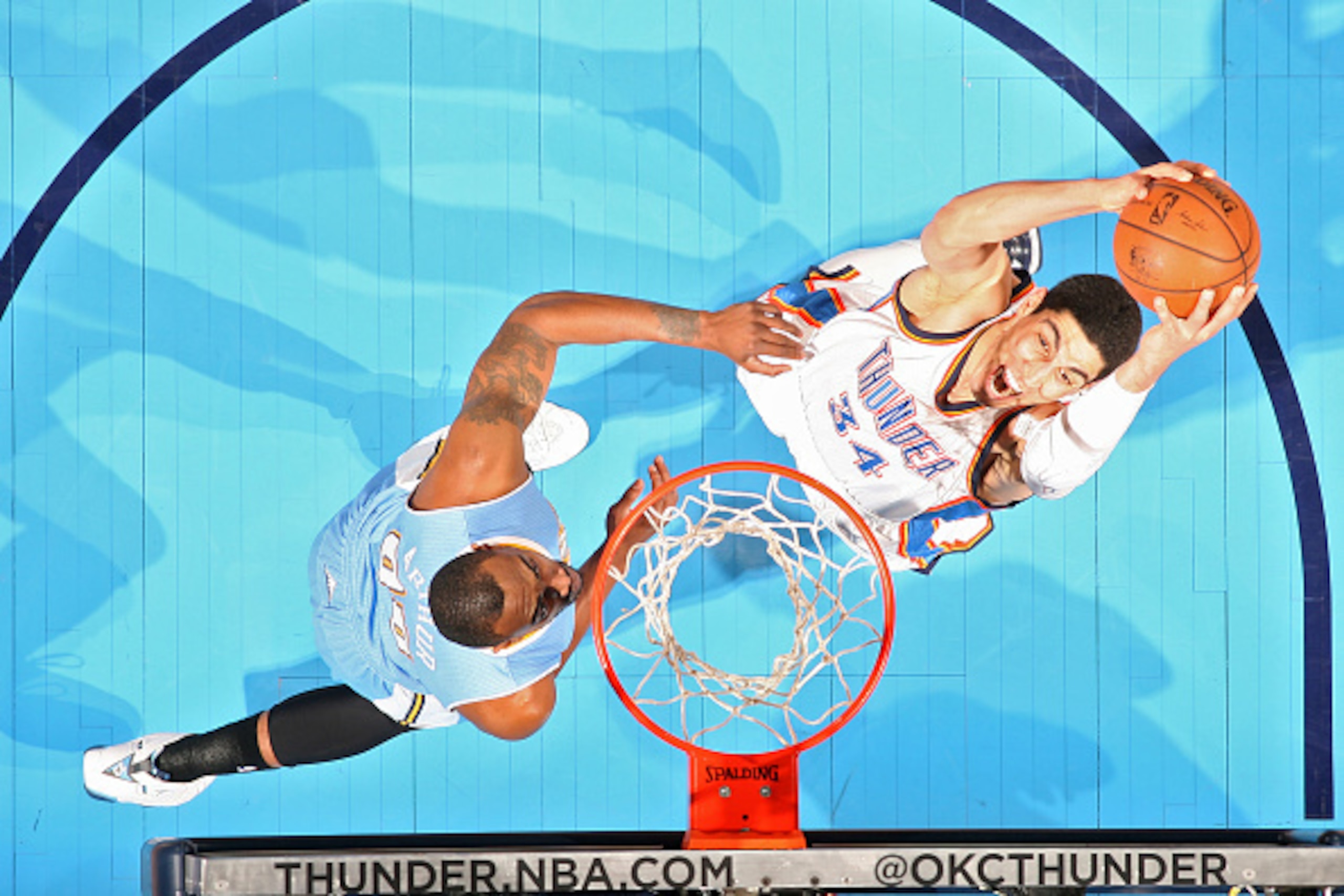 OKLAHOMA CITY, OK - FEBRUARY 22:  Enes Kanter #34 of the Oklahoma City Thunder goes to the basket against the Denver Nuggets on February 22, 2015 at the Chesapeake Energy Arena in Oklahoma City, Oklahoma. NOTE TO USER: User expressly acknowledges and agre