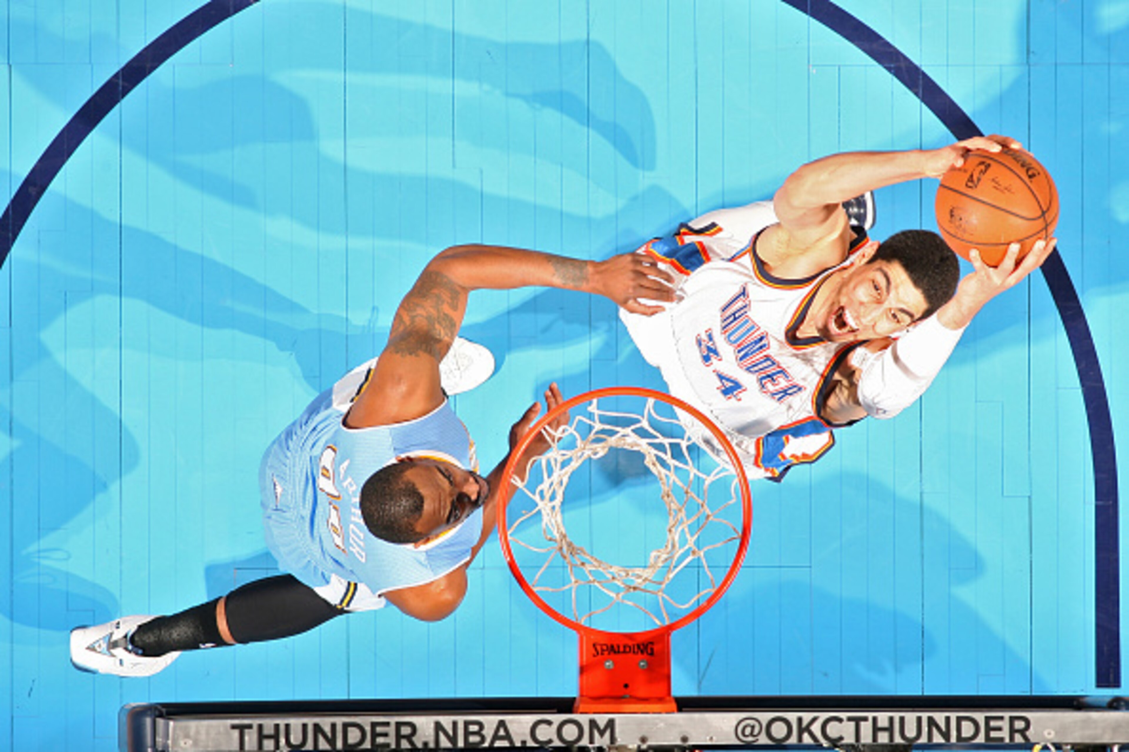OKLAHOMA CITY, OK - FEBRUARY 22:  Enes Kanter #34 of the Oklahoma City Thunder goes to the basket against the Denver Nuggets on February 22, 2015 at the Chesapeake Energy Arena in Oklahoma City, Oklahoma. NOTE TO USER: User expressly acknowledges and agre