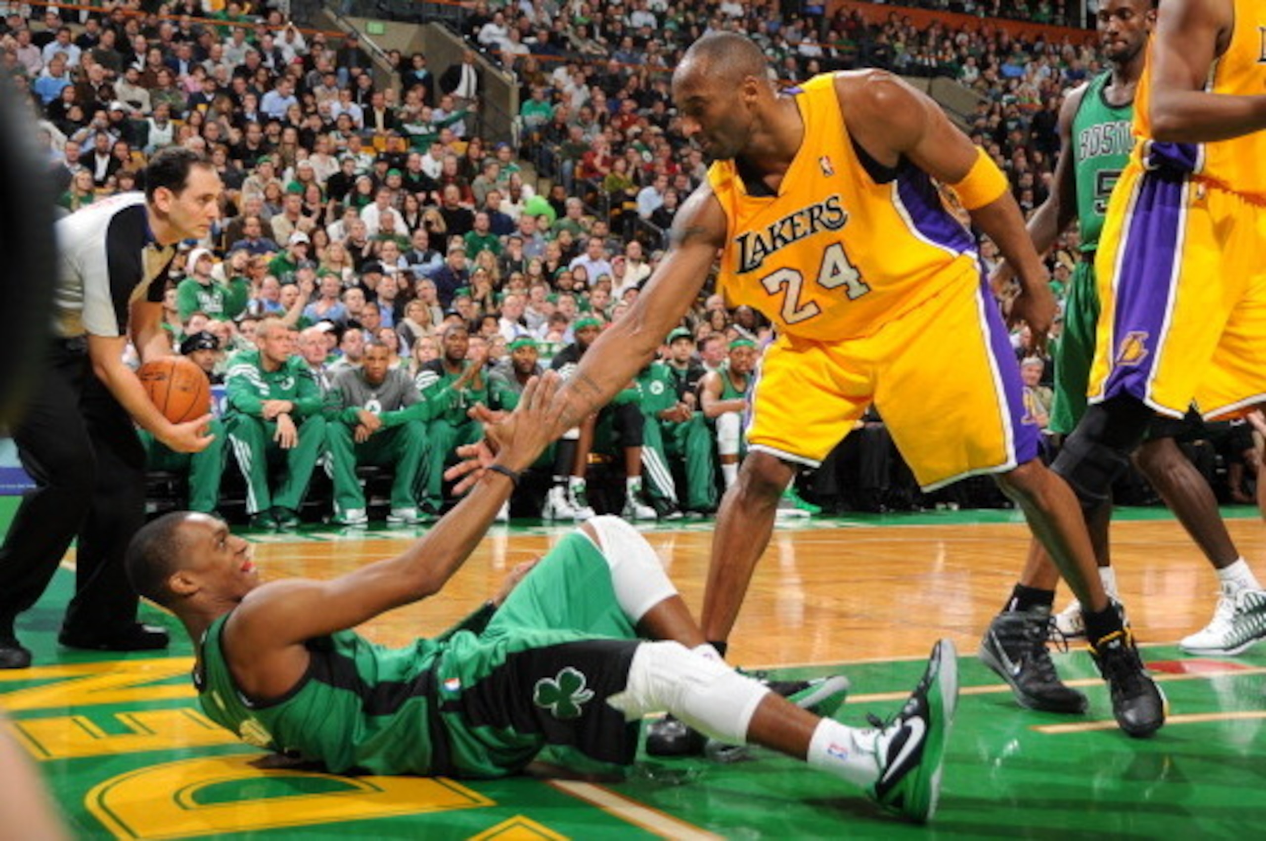 BOSTON, MA - FEBRUARY 9: Kobe Bryant #24 of the Los Angeles Lakers helps up Rajon Rondo #9 of the Boston Celtics on February 9, 2012 at the TD Garden in Boston, Massachusetts. NOTE TO USER: User expressly acknowledges and agrees that, by downloading and o