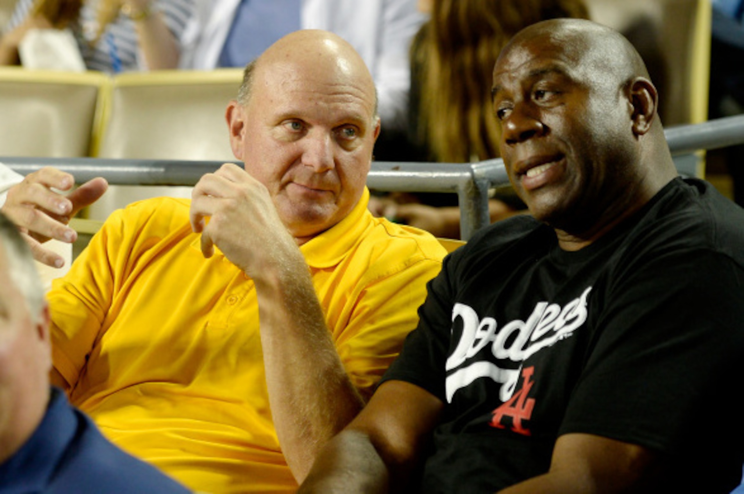 LOS ANGELES, CA - AUGUST 19: Steve Ballmer, (L) former CEO of Microsoft, new owner of Los Angeles Clippers speaks with Earvin 'Magic' Johnson co-owner of Los Angeles Dodgers during the baseball game between the Los Angeles Dodgers and San Diego Padres at 