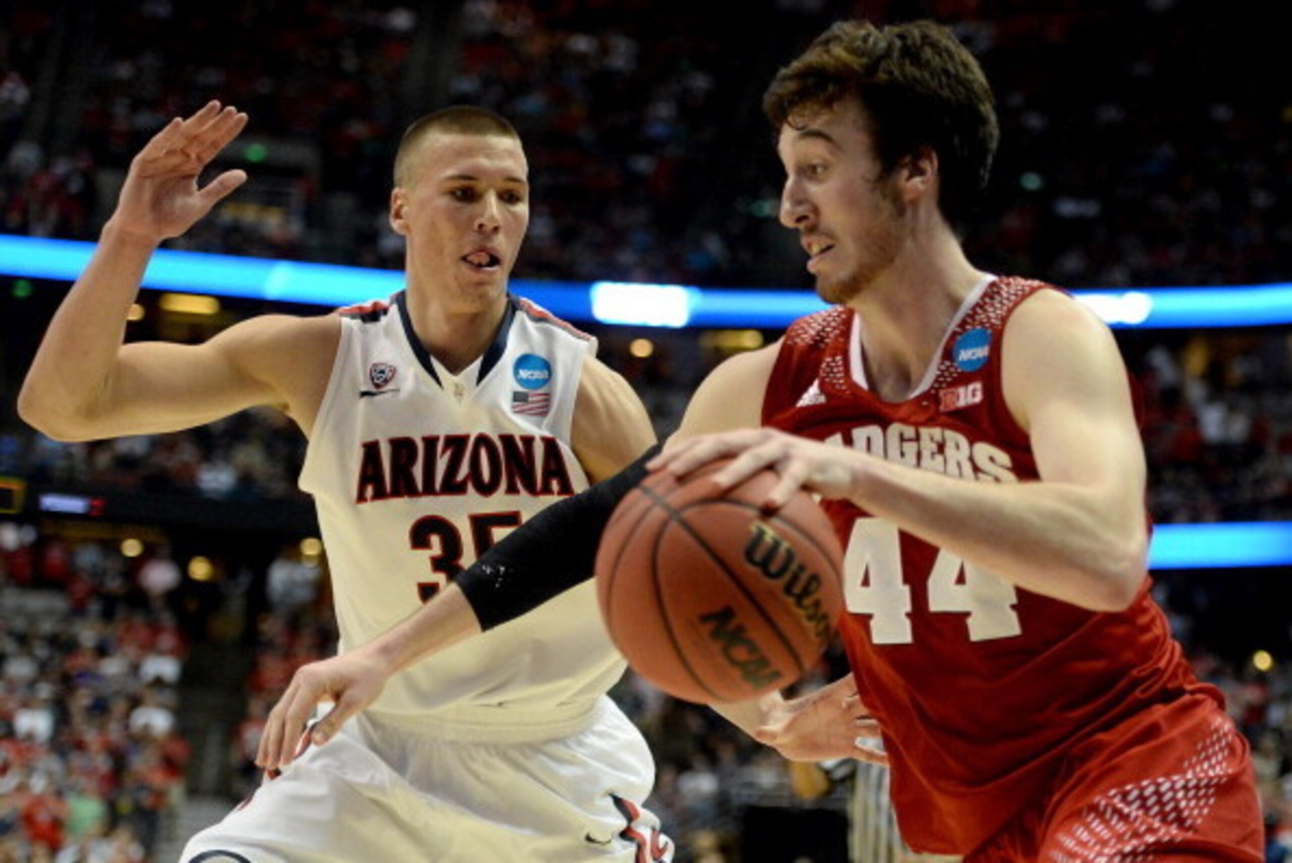 ANAHEIM, CA - MARCH 29:  Frank Kaminsky #44 of the Wisconsin Badgers drives on Kaleb Tarczewski #35 of the Arizona Wildcats in the second half during the West Regional Final of the 2014 NCAA Men's Basketball Tournament at the Honda Center on March 29, 201