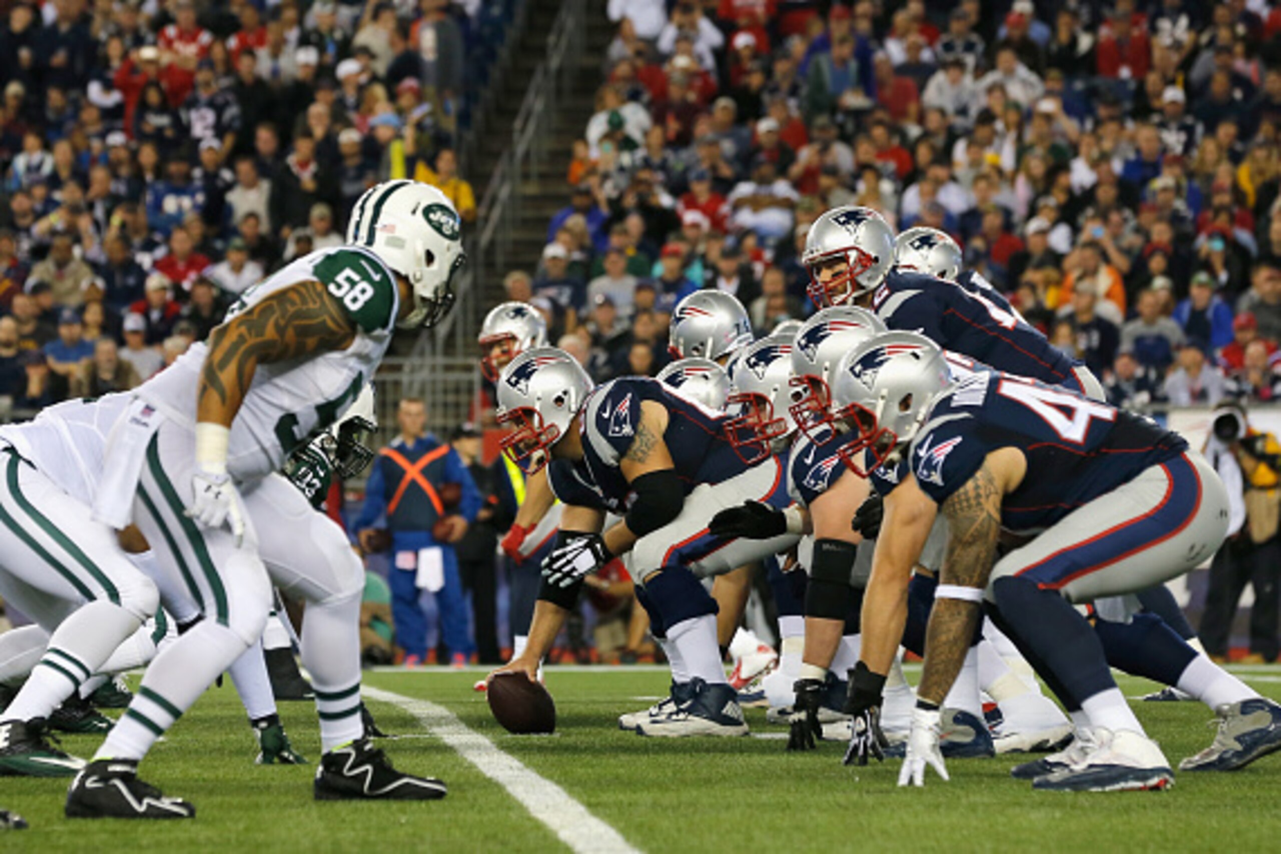 FOXBORO, MA - OCTOBER 16:  Tom Brady #12 of the New England Patriots at the line of scrimmage during the second quarter against the New York Jets at Gillette Stadium on October 16, 2014 in Foxboro, Massachusetts.  (Photo by Jim Rogash/Getty Images)