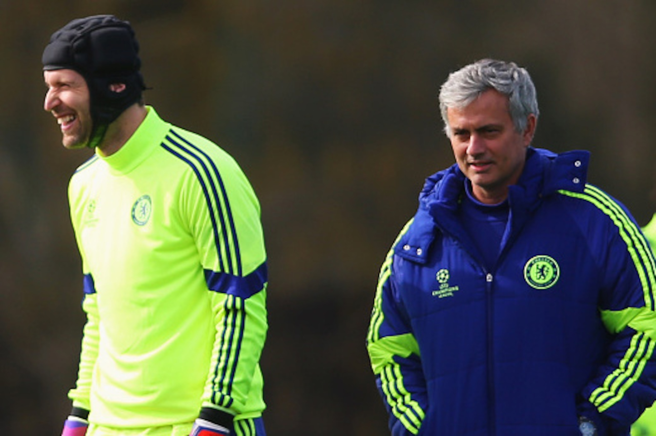 COBHAM, ENGLAND - MARCH 10:  Jose Mourinho manager of Chelsea (R) and goalkeeper Petr Cech (2R) smile during a Chelsea training session ahead of the UEFA Champions League Round of 16 second leg match against Paris Saint-Germain at Chelsea Training Ground 