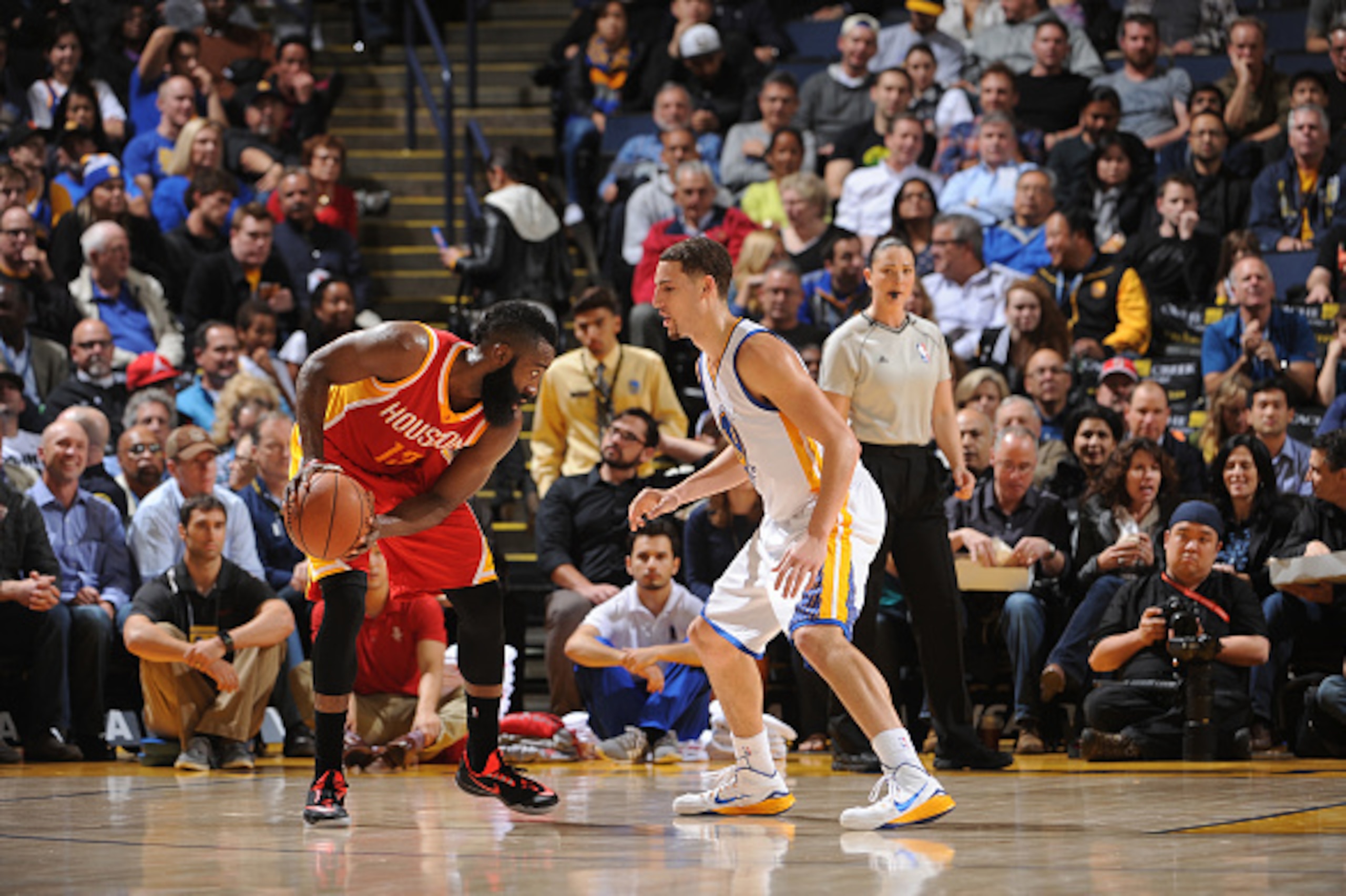 OAKLAND, CA - DECEMBER 10: James Harden #13 of the Houston Rockets handles the ball against Klay Thompson #11 of the Golden State Warriors on December 10, 2014 at Oracle Arena in Oakland, California. NOTE TO USER: User expressly acknowledges and agrees th