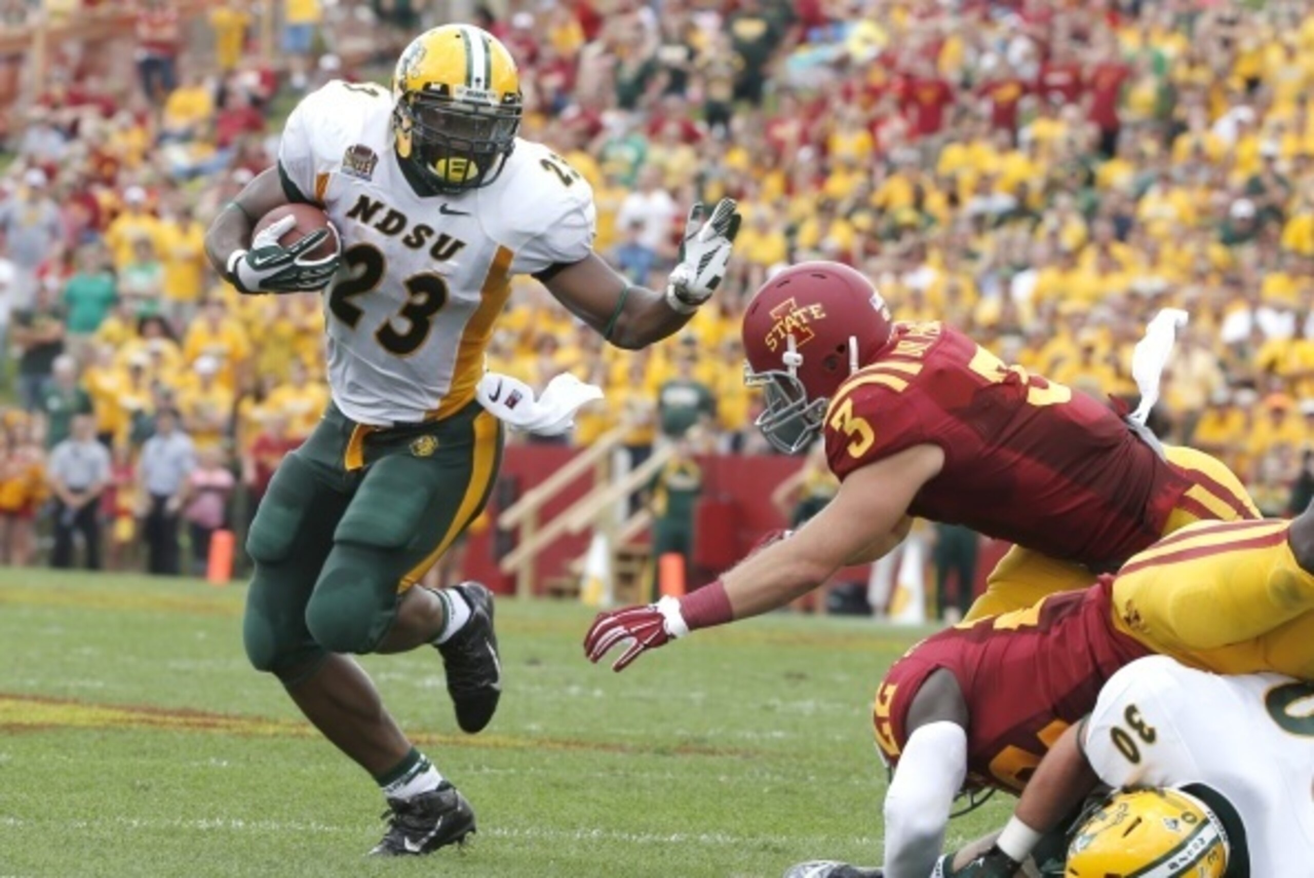 AMES, IA - AUGUST 30: Running back John Crockett #23 of the North Dakota State Bison rushes for yards past linebacker Drake Ferch #3 of the Iowa State Cyclones in the first half of play at Jack Trice Stadium on August 30, 2014 in Ames, Iowa. (Photo by Dav