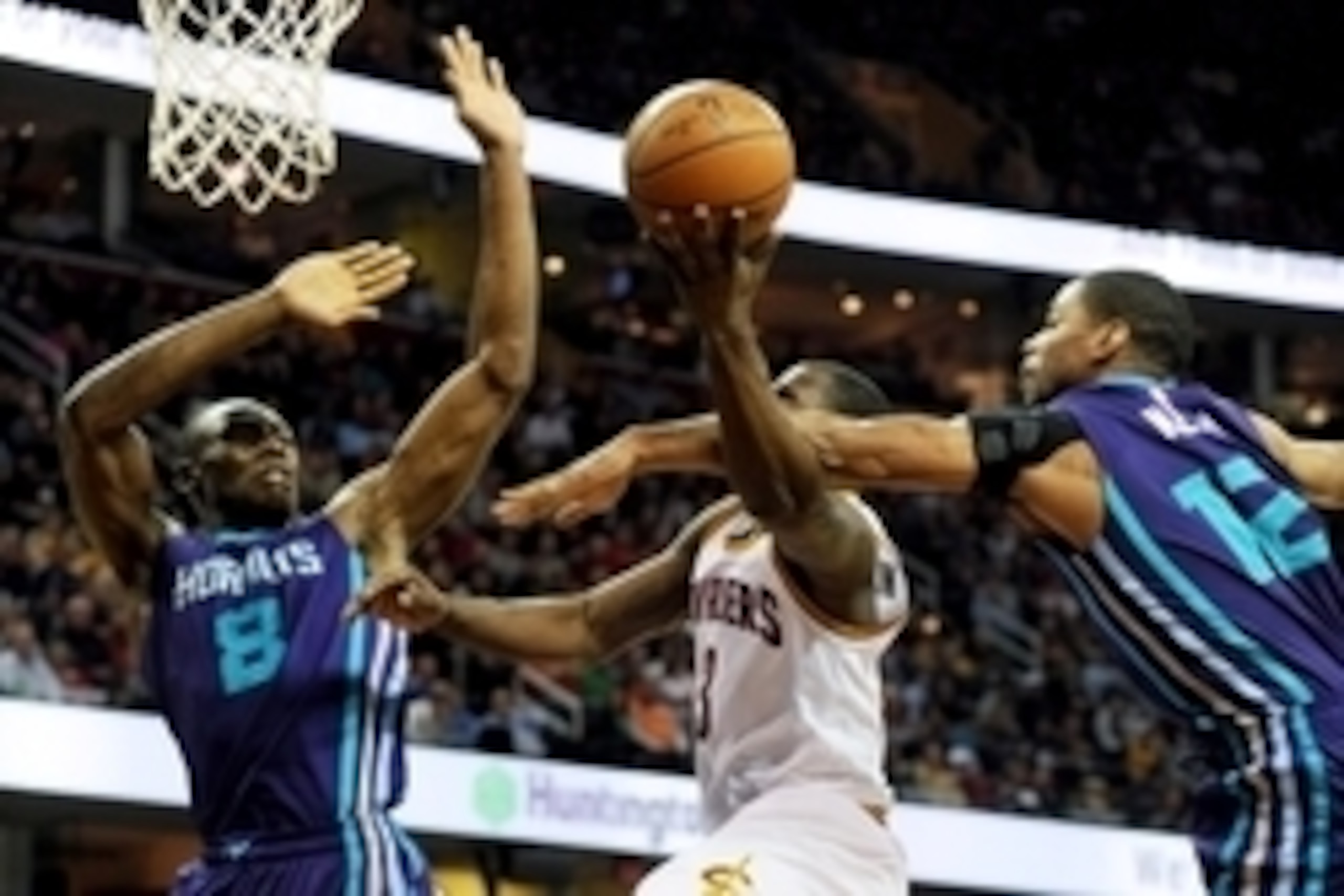 Dec 15, 2014; Cleveland, OH, USA; Charlotte Hornets center Bismack Biyombo (8) and guard Gary Neal (12) defend against Cleveland Cavaliers guard Dion Waiters (3) during the second quarter at Quicken Loans Arena. Mandatory Credit: Ken Blaze-USA TODAY Sport