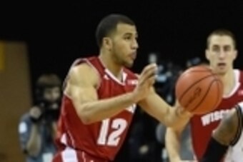Dec 10, 2014; Milwaukee, WI, USA;  Wisconsin Badgers guard Traevon Jackson (12) passes the ball away from UW-Milwaukee Panthers guard JeVon Lyle (30) in the first half at U.S. Cellular Arena. Mandatory Credit: Benny Sieu-USA TODAY Sports