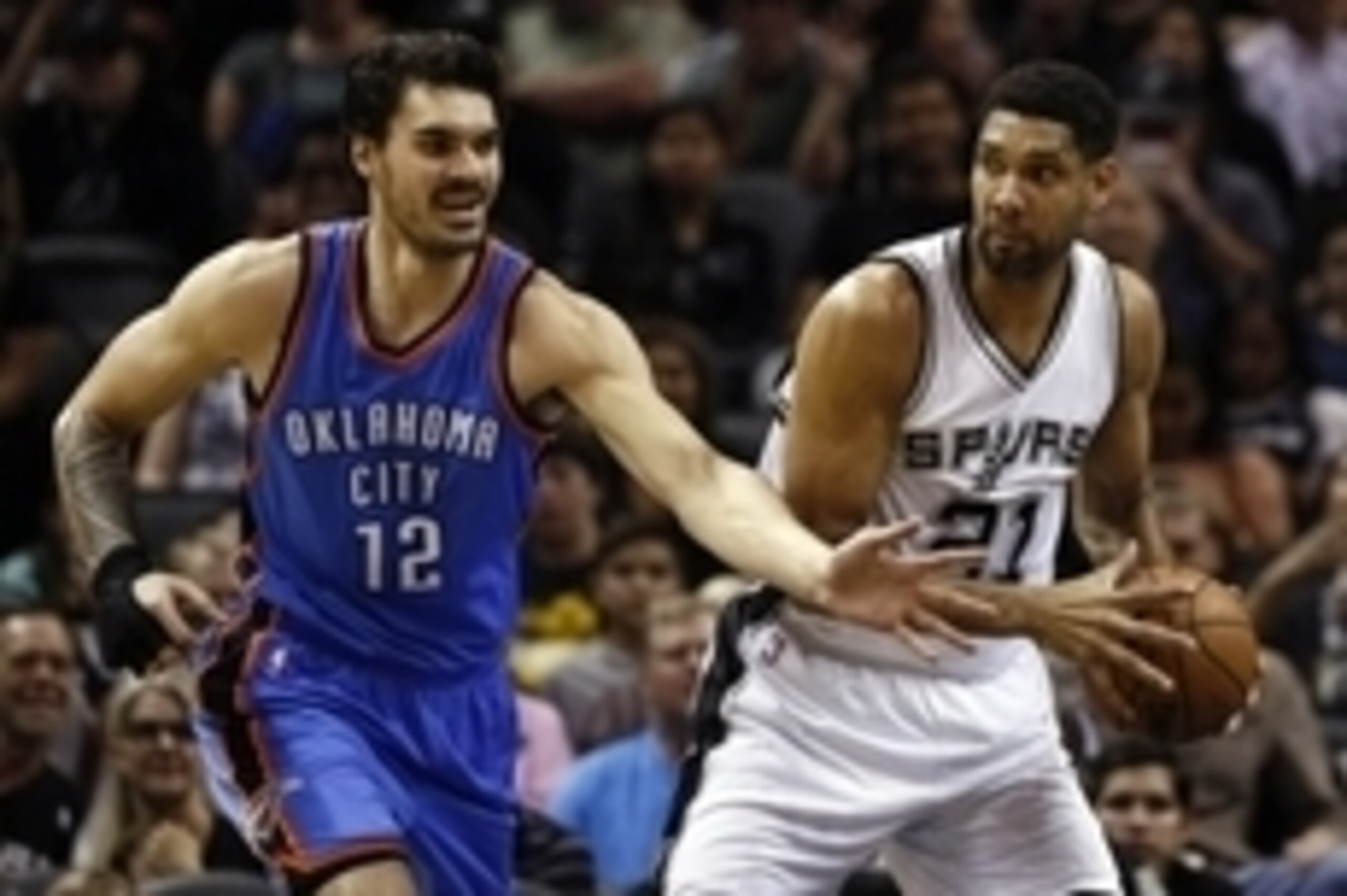 Mar 25, 2015; San Antonio, TX, USA; San Antonio Spurs power forward Tim Duncan (21) passes the ball as Oklahoma City Thunder center Steven Adams (12) defends during the first half at AT&T Center. Mandatory Credit: Soobum Im-USA TODAY Sports