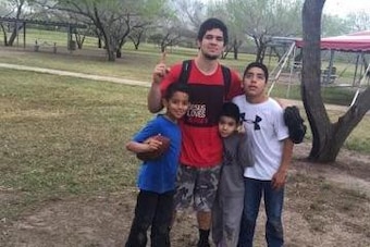 Silas playing football with children on spring break.