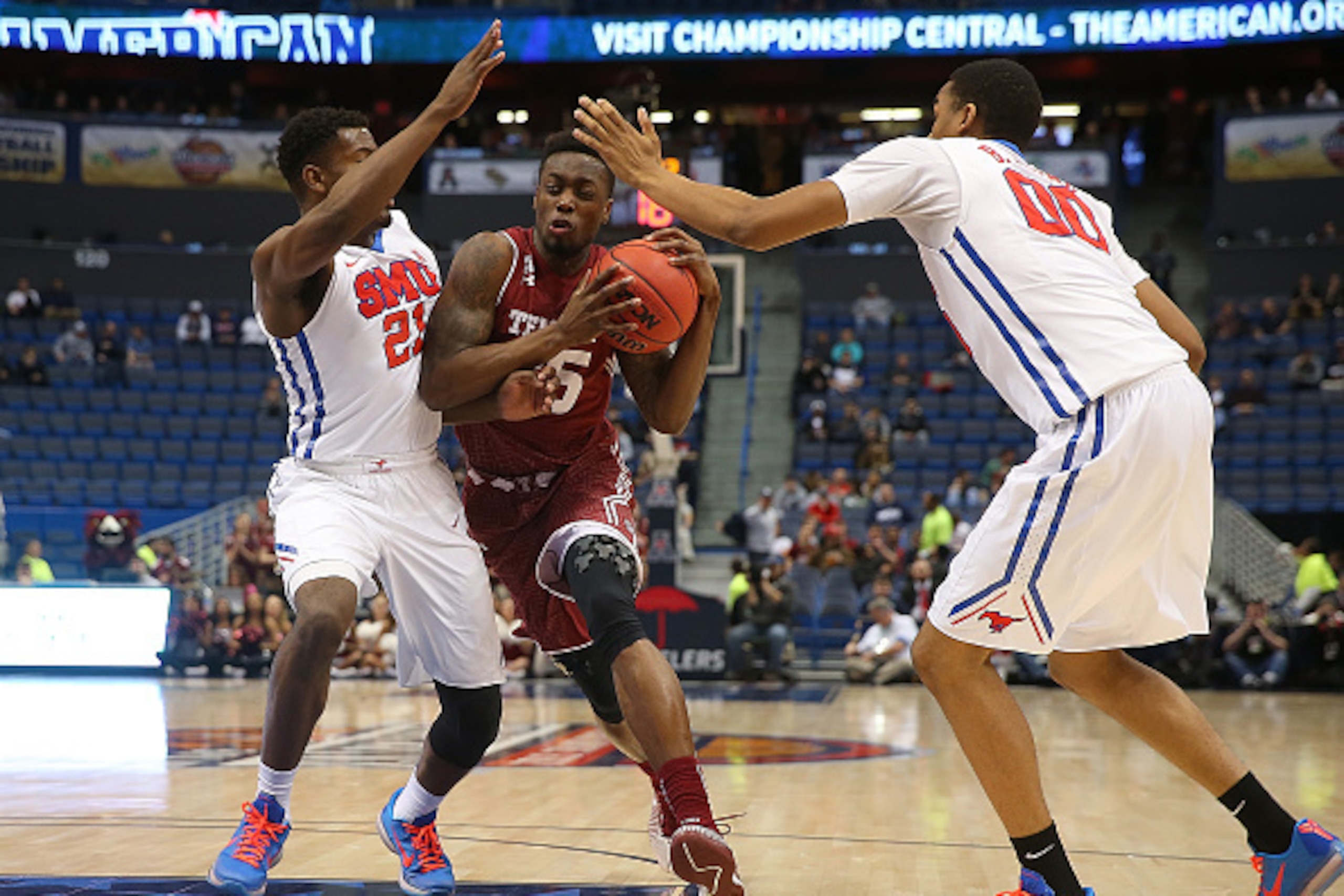HARTFORD, CT - MARCH 14:   Quenton DeCosey #25 of the Temple Owls runs in to Ben Emelogu #21 of the Southern Methodist Mustangs during a semifinal  game  of the American 2015 Championships at the XL Center on March, 14, 2015 in Hartford, Connecticut. (Pho
