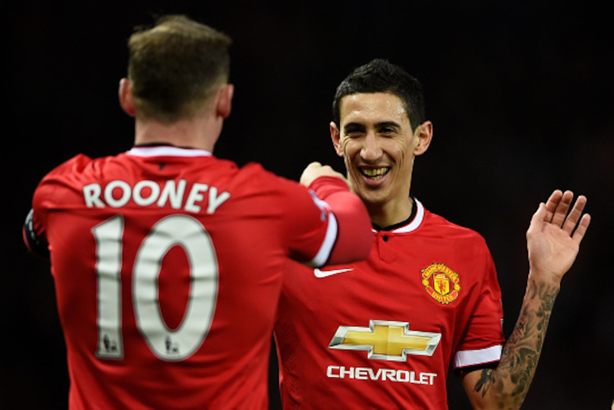 MANCHESTER, ENGLAND - MARCH 09:  Provider of the goal scoring cross Angel di Maria (R) of Manchester United congratultes the scorer Wayne Rooney of Manchester United after the scores are levelled at 1-1 during the FA Cup Quarter Final match between Manche