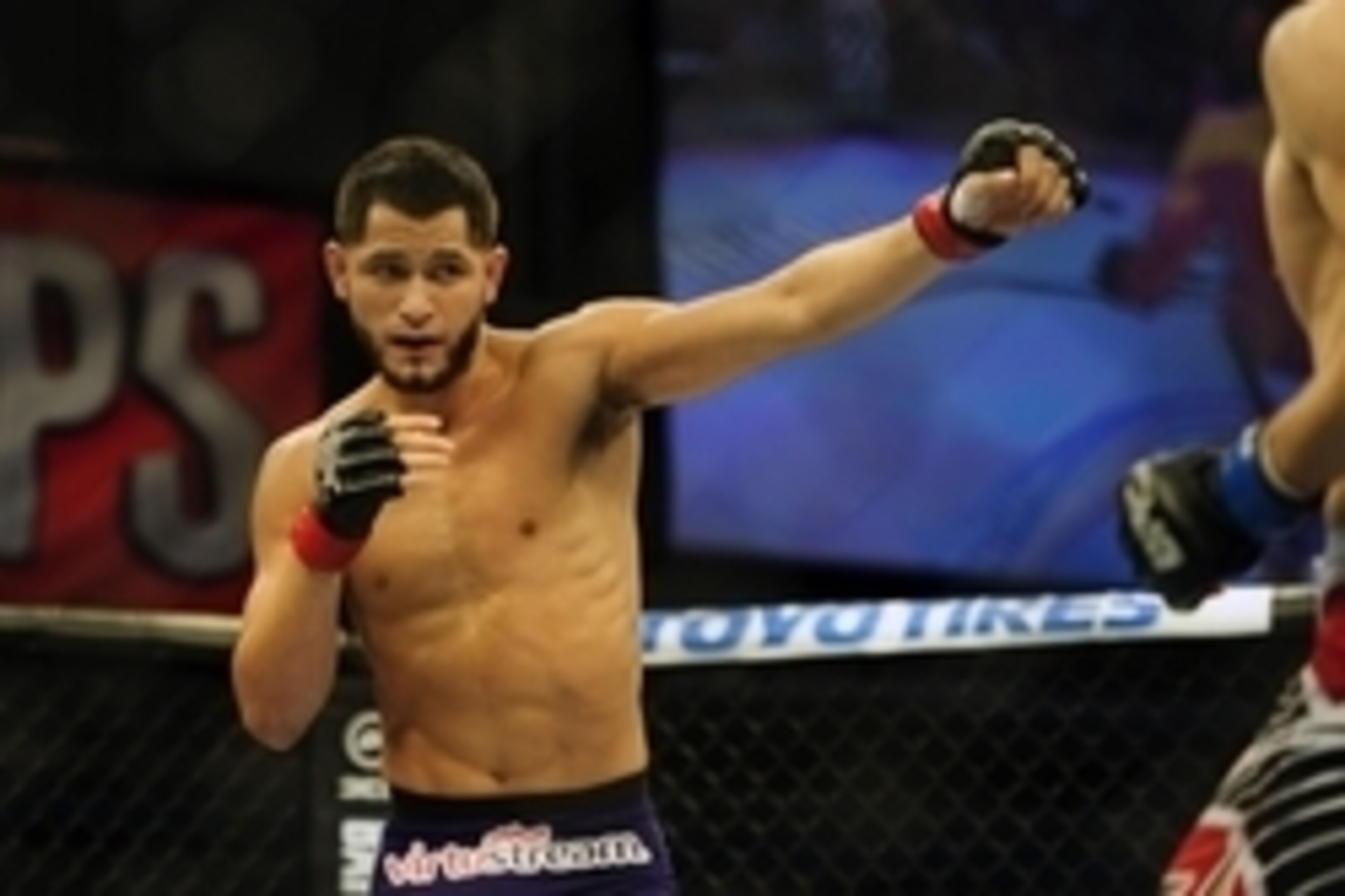 Nov 6, 2013; Fort Campbell, KY, USA; Jorge Masvidal (red gloves) fights Rustam Khabilov (blue gloves) in the lightweight bout during UFC Fight for the Troops at Fort Campbell. Mandatory Credit: Joshua Lindsey-USA TODAY Sports