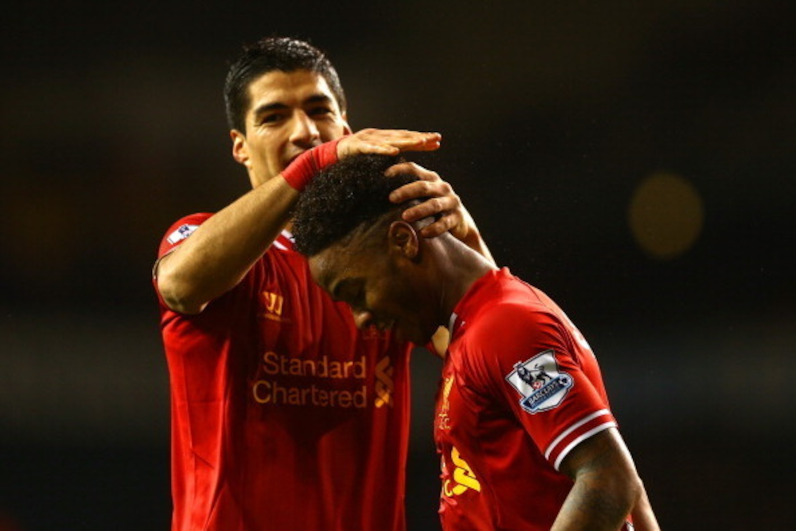 LONDON, ENGLAND - DECEMBER 15:  Luis Suarez of Liverpool congratulates Raheem Sterling of Liverpool on scoring their fifth goal during the Barclays Premier League match between Tottenham Hotspur and Liverpool at White Hart Lane on December 15, 2013 in Lon
