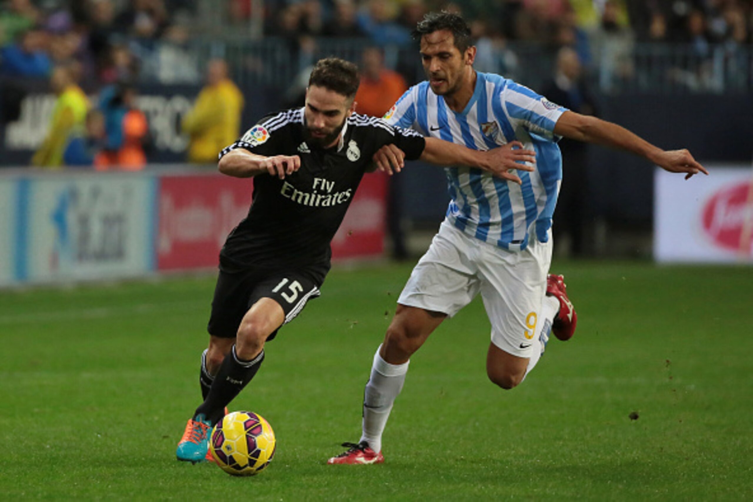 MALAGA, SPAIN - NOVEMBER 29:  Daniel Carvajal of Real Madrid (L) duels for the ball with Roque Santa Cruz of Malaga CF during the La Liga match between Malaga CF and Real Madrid CF at La Rosaleda studium on November 29, 2014 in Malaga, Spain. (Photo by Se