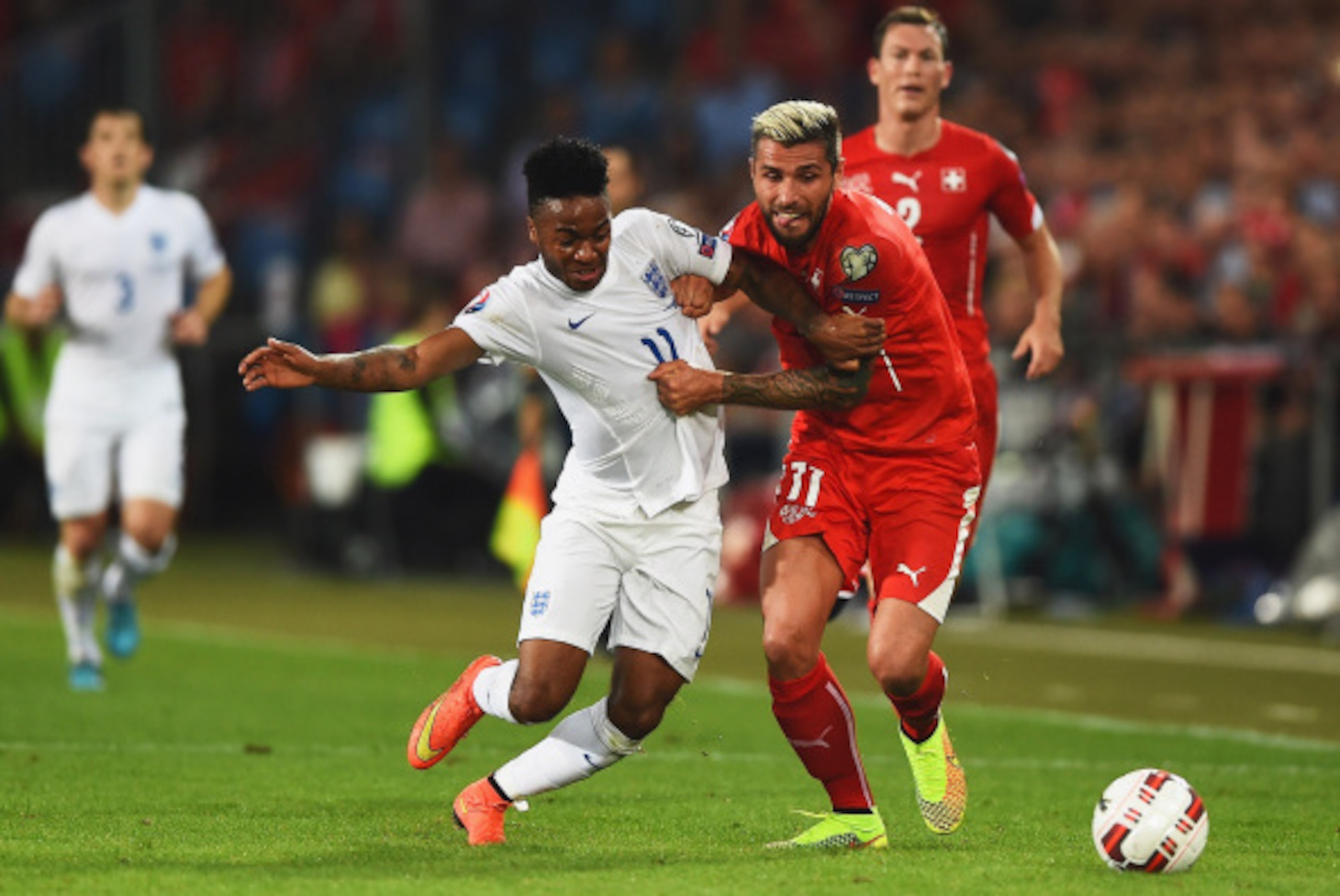 BASEL, SWITZERLAND - SEPTEMBER 08:  Raheem Sterling of England battles with Valon Behrami of Switzerland during the UEFA EURO 2016 Group E qualifying match between Switzerland and England at St Jakob-Park on September 8, 2014 in Basel, Switzerland.  (Phot