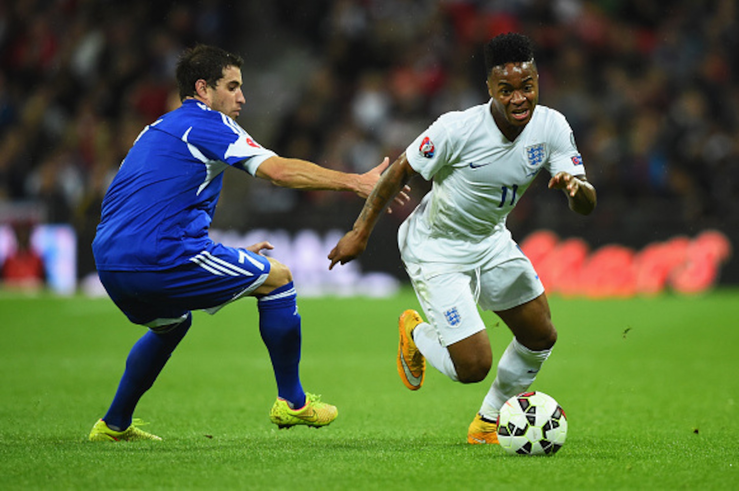 LONDON, ENGLAND - OCTOBER 09:  Raheem Sterling of England evades Adolfo Jose Hirsch of San Marino during the EURO 2016 Group E Qualifying match between England and San Marino at Wembley Stadium on October 9, 2014 in London, England.  (Photo by Mike Hewitt