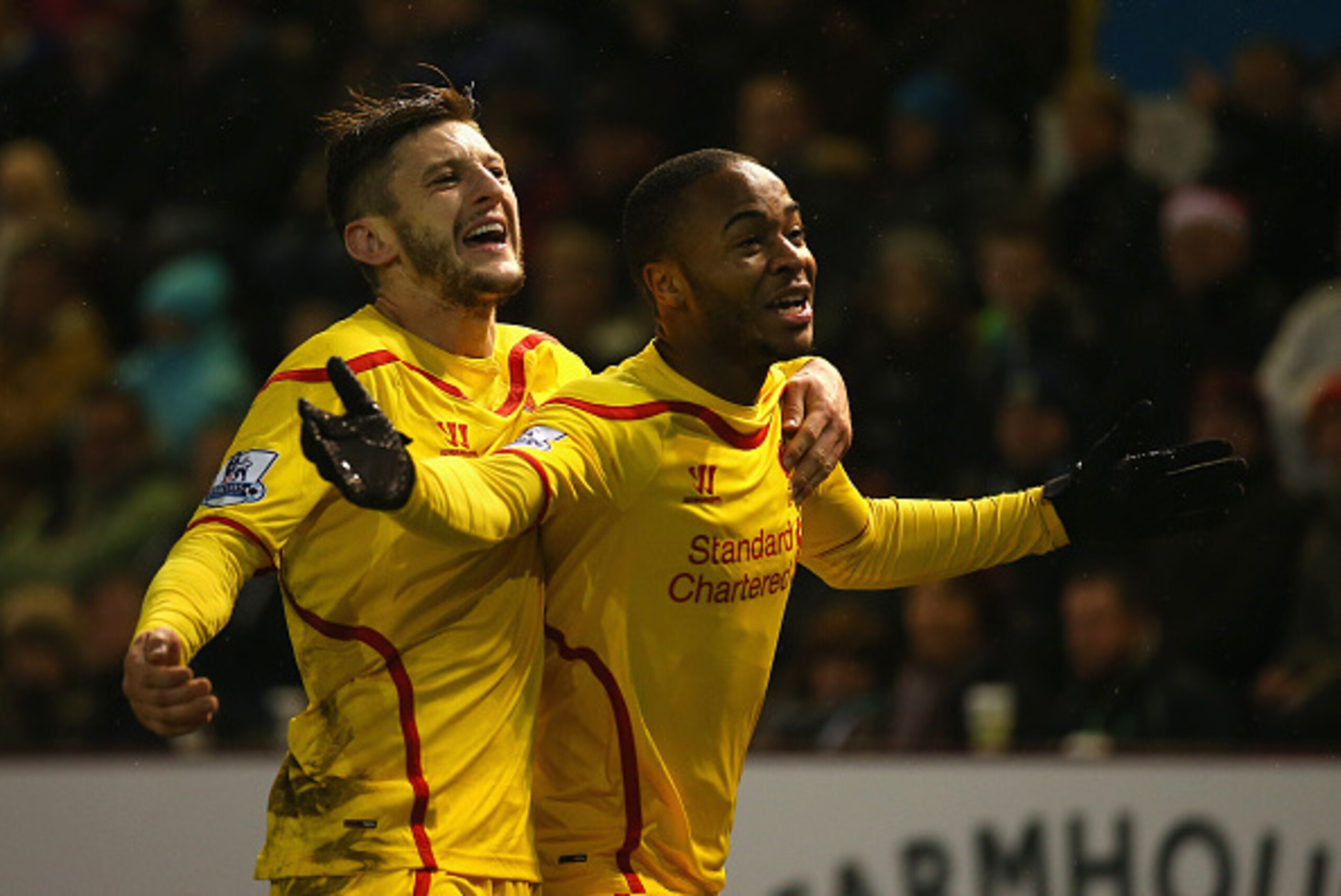 BURNLEY, ENGLAND - DECEMBER 26:  Raheem Sterling (R) of Liverpool celebrates scoring the opening goal with Adam Lallana during the Barclays Premier League match between Burnley and Liverpool at Turf Moor on December 26, 2014 in Burnley, England.  (Photo b