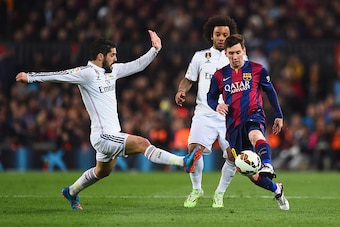 BARCELONA, SPAIN - MARCH 22:  Lionel Messi of Barcelona takes on Isco (L) and Marcelo of Real Madrid CF (C) during the La Liga match between FC Barcelona and Real Madrid CF at Camp Nou on March 22, 2015 in Barcelona, Spain.  (Photo by Alex Caparros/Getty 