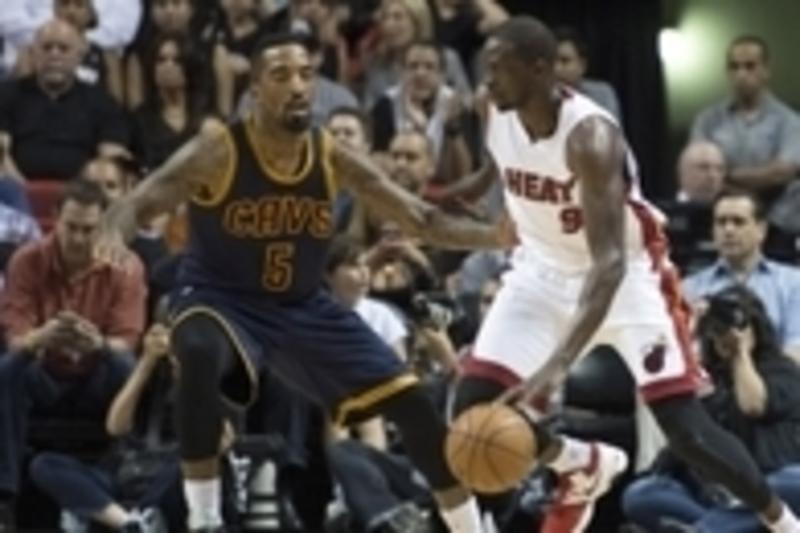 Mar 16, 2015; Miami, FL, USA; Miami Heat forward Luol Deng (9) dribbles as Cleveland Cavaliers guard J.R. Smith (5) defends during the first quarter at American Airlines Arena. Mandatory Credit: Tommy Gilligan-USA TODAY Sports