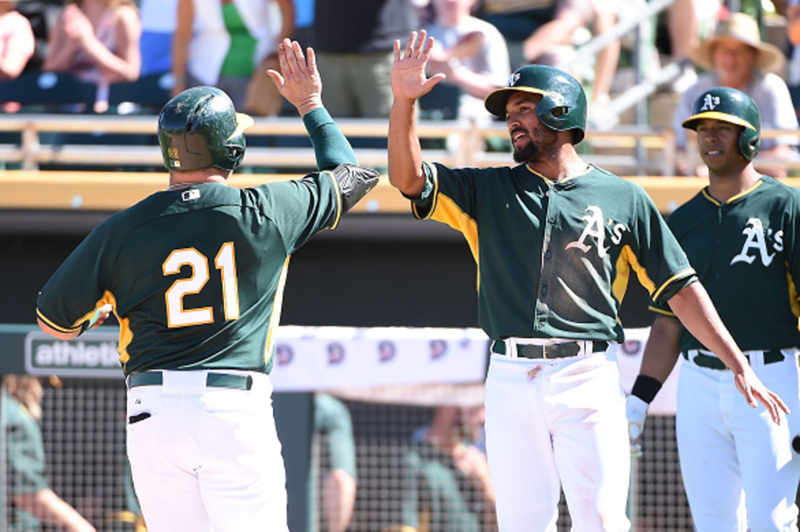 MESA, AZ - MARCH 24:  Stephen Vogt #21 of the Oakland Athletics celebrates with teammate Marcus Semien #10 after hitting a third-inning home run against the Chicago Cubs in a preseason Cactus League game at HoHokam Stadium on March 24, 2015 in Mesa, Arizo