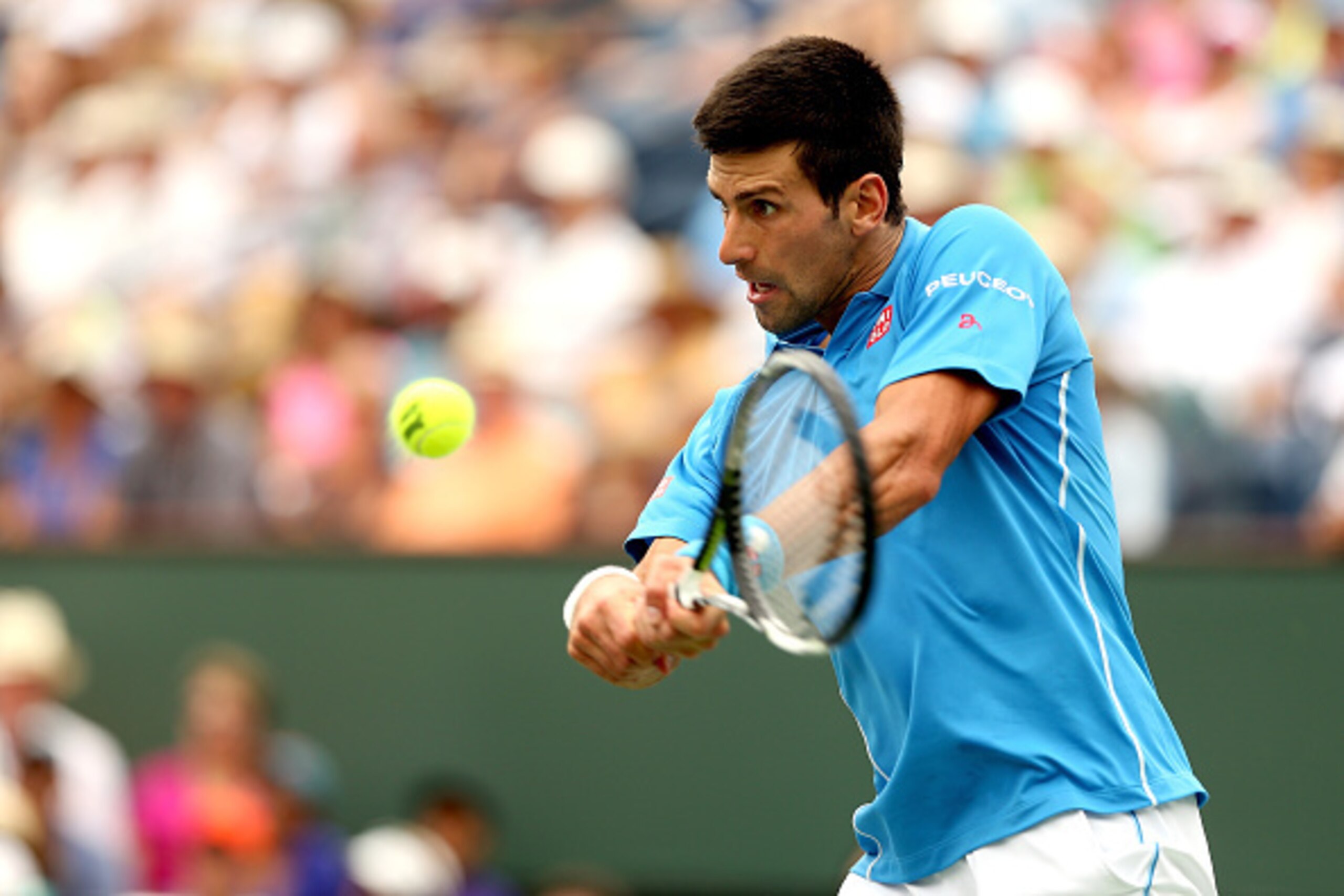 INDIAN WELLS, CA - MARCH 22:  Novak Djokovic of Serbia returns a shot to Roger Federer of Switzerland during the final on day fourteen of the BNP Paribas Open at the Indian Wells Tennis Garden on March 22, 2015 in Indian Wells, California.  (Photo by Matt