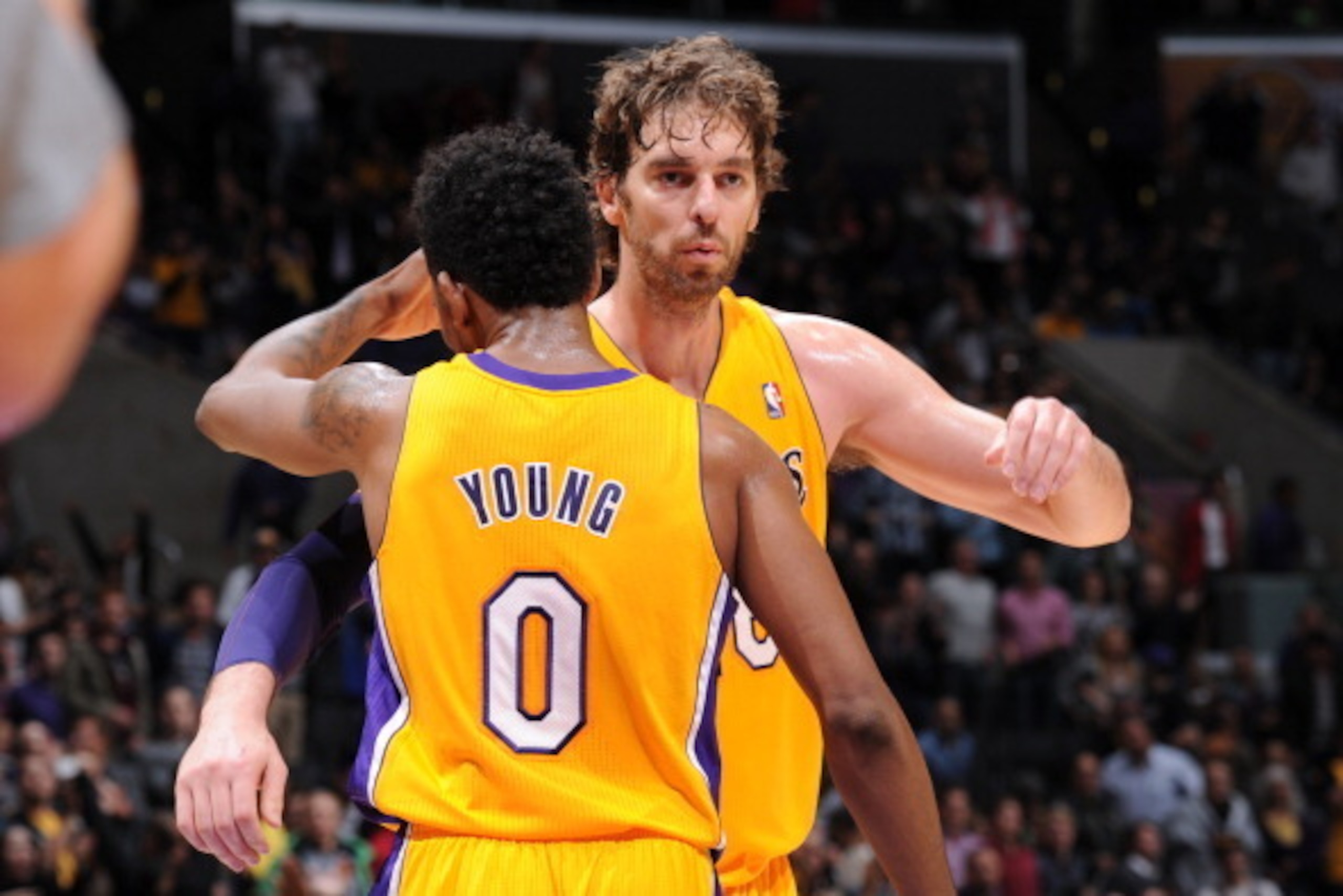 LOS ANGELES, CA - NOVEMBER 22: Pau Gasol #16 and Nick Young #0 of the Los Angeles Lakers embrace during a game against the Golden State Warriors on November 22, 2013 at STAPLES Center in Los Angeles, California. NOTE TO USER: User expressly acknowledges a