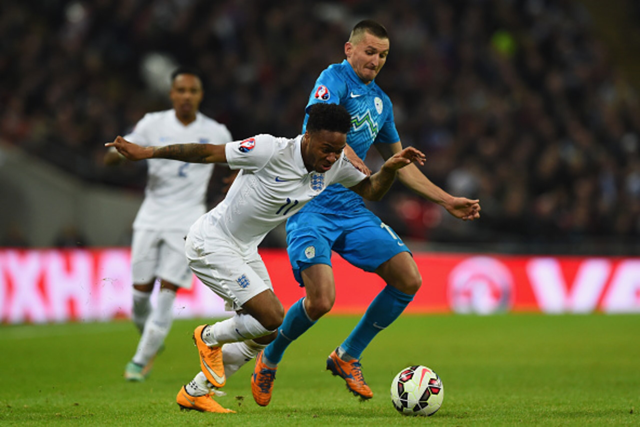 LONDON, ENGLAND - NOVEMBER 15: Raheem Sterling of England is tackled by Milivoje Novakovic of Slovenia (R) during the EURO 2016 Qualifier Group E match between England and Slovenia at Wembley Stadium on November 15, 2014 in London, England. (Photo by Sh LONDON, ENGLAND - NOVEMBER 15: Raheem Sterling of England is tackled by Milivoje Novakovic of Slovenia (R) during the EURO 2016 Qualifier Group E match between England and Slovenia at Wembley Stadium on November 15, 2014 in London, England. (Photo by Sh