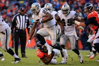 DENVER, CO - DECEMBER 28:  Running back Latavius Murray #28 of the Oakland Raiders rushes against the Denver Broncos during a game at Sports Authority Field at Mile High on December 28, 2014 in Denver, Colorado.  (Photo by Doug Pensinger/Getty Images)