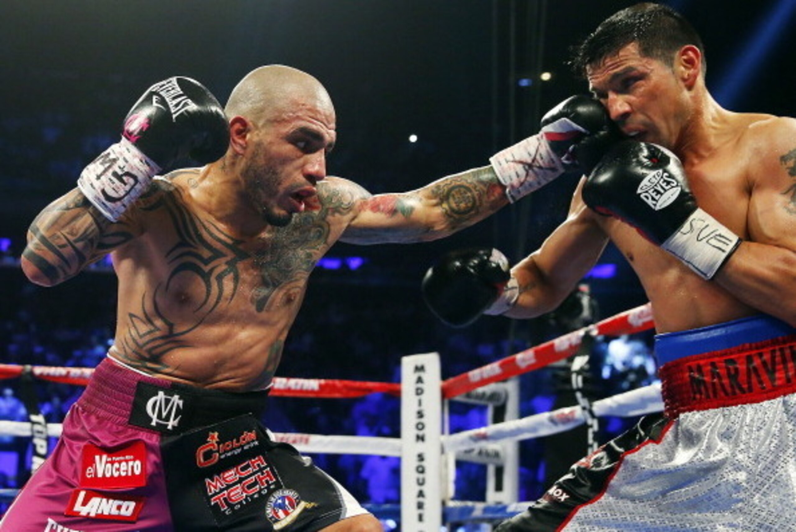 NEW YORK, NY - JUNE 07: Miguel Cotto of Puerto Rico lands a left punch to the face of Sergio Martinez of Argentina during the third round of the WBC Middleweight Championship fight on June 7, 2014 at Madison Square Garden in New York City. Cotto won by a NEW YORK, NY - JUNE 07: Miguel Cotto of Puerto Rico lands a left punch to the face of Sergio Martinez of Argentina during the third round of the WBC Middleweight Championship fight on June 7, 2014 at Madison Square Garden in New York City. Cotto won by a