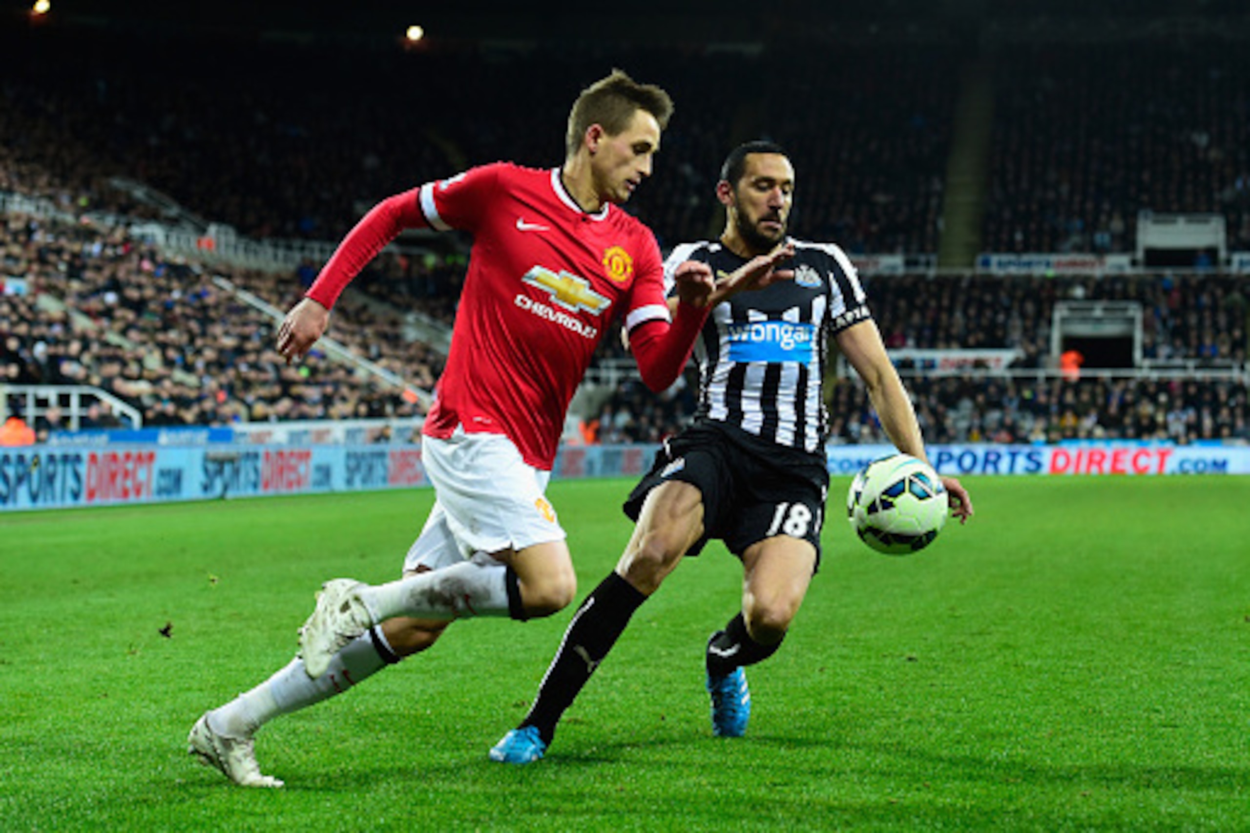 NEWCASTLE UPON TYNE, ENGLAND - MARCH 04:  Jonas Gutierrez (r) of Newcastle challenges Adnan Januzaj of Manchester United during the Barclays Premier League match between Newcastle United and Manchester United at St James' Park on March 4, 2015 in Newcastl