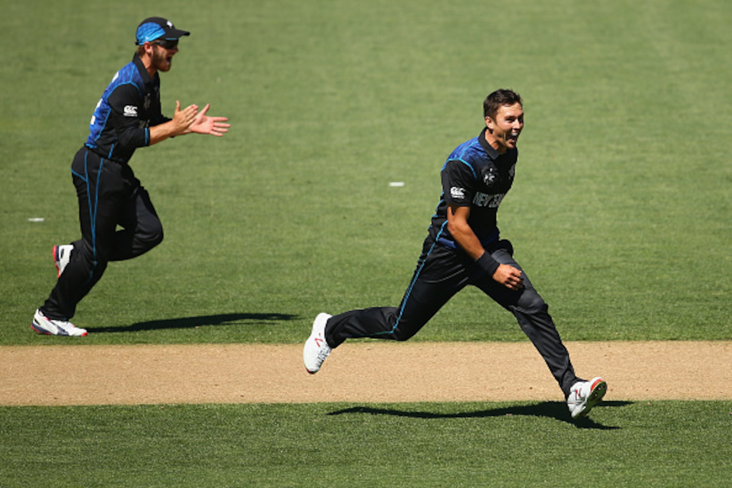 AUCKLAND, NEW ZEALAND - FEBRUARY 28:  Grant Elliott and Trent Boult celebrate Boult taking the wicket of Mitch Marsh of Australia during the 2015 ICC Cricket World Cup match between Australia and New Zealand at Eden Park on February 28, 2015 in Auckland, 