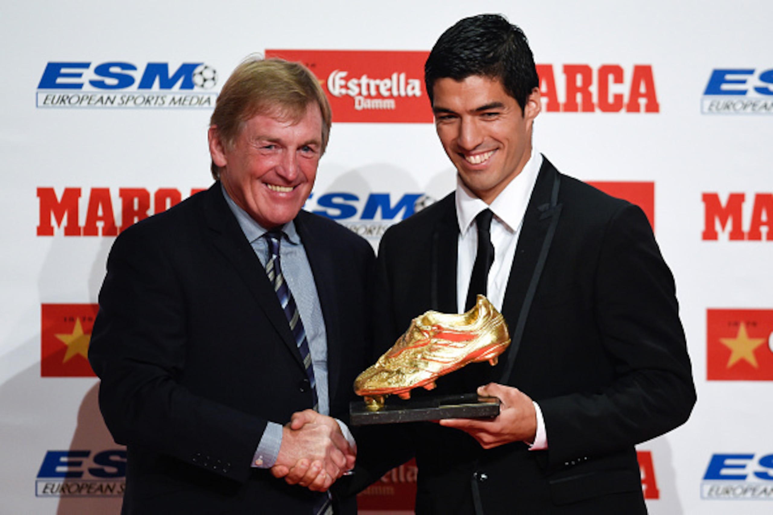 BARCELONA, SPAIN - OCTOBER 15:  Kenny Dalglish presents the Golden Boot Trophy to Luis Suarez as the best goal scorer in all European Leagues last season on October 15, 2014 in Barcelona, Spain. Luis Suarez scored 31 goals for Liverpool in last season's P