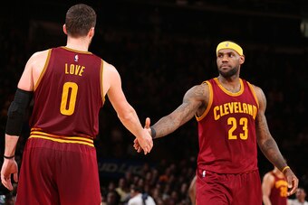 NEW YORK, NY - FEBRUARY 22: LeBron James #23 high fives teammate Kevin Love #0 of the Cleveland Cavaliers during the game on February 22, 2015 at Madison Square Garden in New York, New York. NOTE TO USER: User expressly acknowledges and agrees that, by do