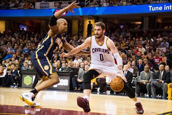 CLEVELAND, OH - MARCH 20: Kevin Love #0 of the Cleveland Cavaliers drives around David West #21 of the Indiana Pacers during the first half at Quicken Loans Arena on March 20, 2015 in Cleveland, Ohio. NOTE TO USER: User expressly acknowledges and agrees t