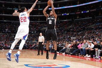 LOS ANGELES, CA - FEBRUARY 19:  Kawhi Leonard #2 of the San Antonio Spurs shoots against Matt Barnes #22 of the Los Angeles Clippers on February 19, 2015 at Staples Center in Los Angeles, California. NOTE TO USER: User expressly acknowledges and agrees th