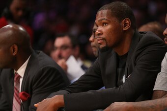 LOS ANGELES, CA - MARCH 01:  Injured player Kevin Durant of the Oklahoma City Thunder looks on from the bench during the game against the Los Angeles Lakers at Staples Center on March 1, 2015 in Los Angeles, California.  The Thunder won 108-101.   NOTE TO