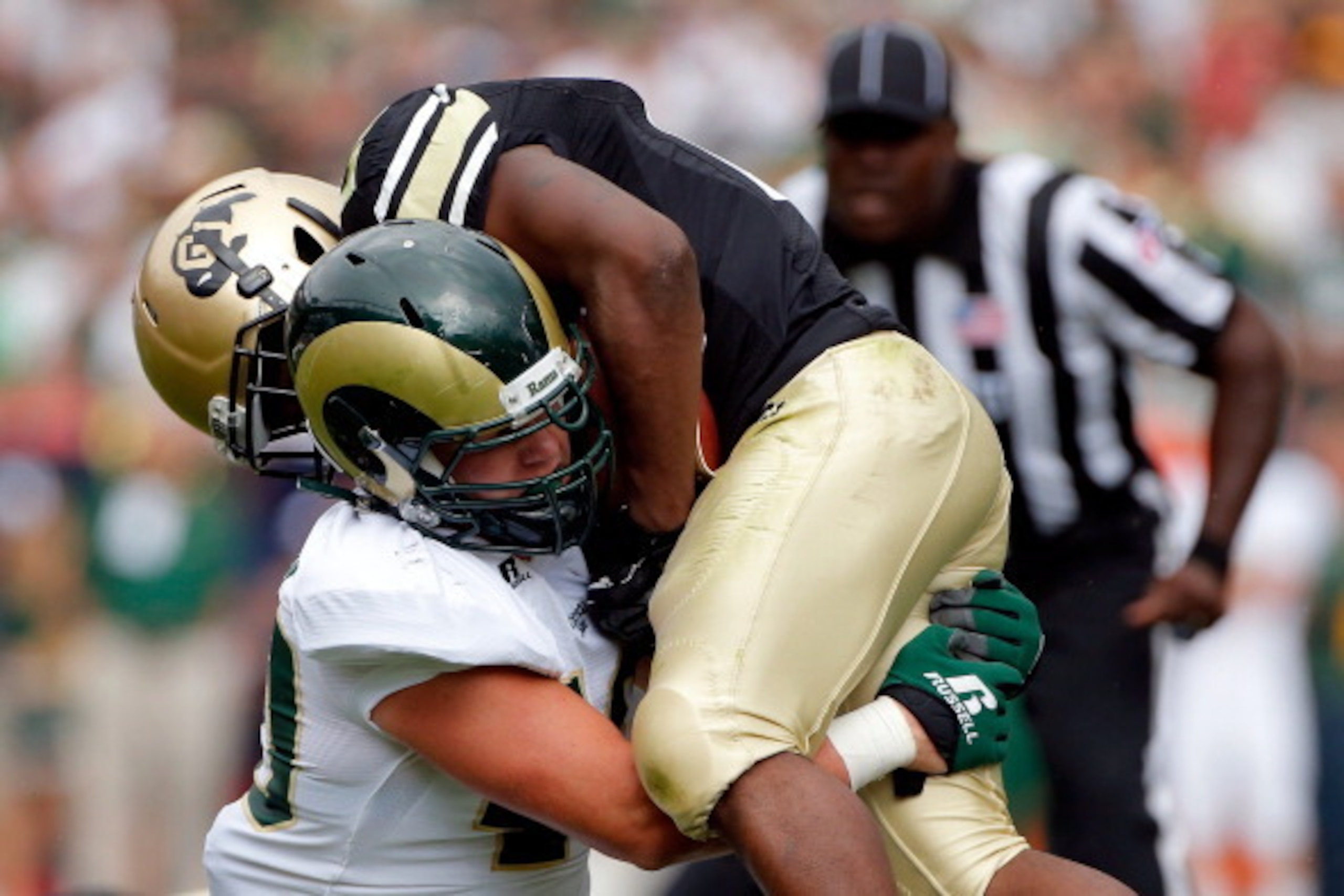DENVER, CO - SEPTEMBER 01: Running back Tony Jones #26 of the Colorado Buffaloes is tackled by linebacker Max Morgan #40 of the Colorado State Rams in the Rocky Mountain Showdown at Sports Authority Field at Mile High on September 1, 2012 in Denver, Colo DENVER, CO - SEPTEMBER 01: Running back Tony Jones #26 of the Colorado Buffaloes is tackled by linebacker Max Morgan #40 of the Colorado State Rams in the Rocky Mountain Showdown at Sports Authority Field at Mile High on September 1, 2012 in Denver, Colo