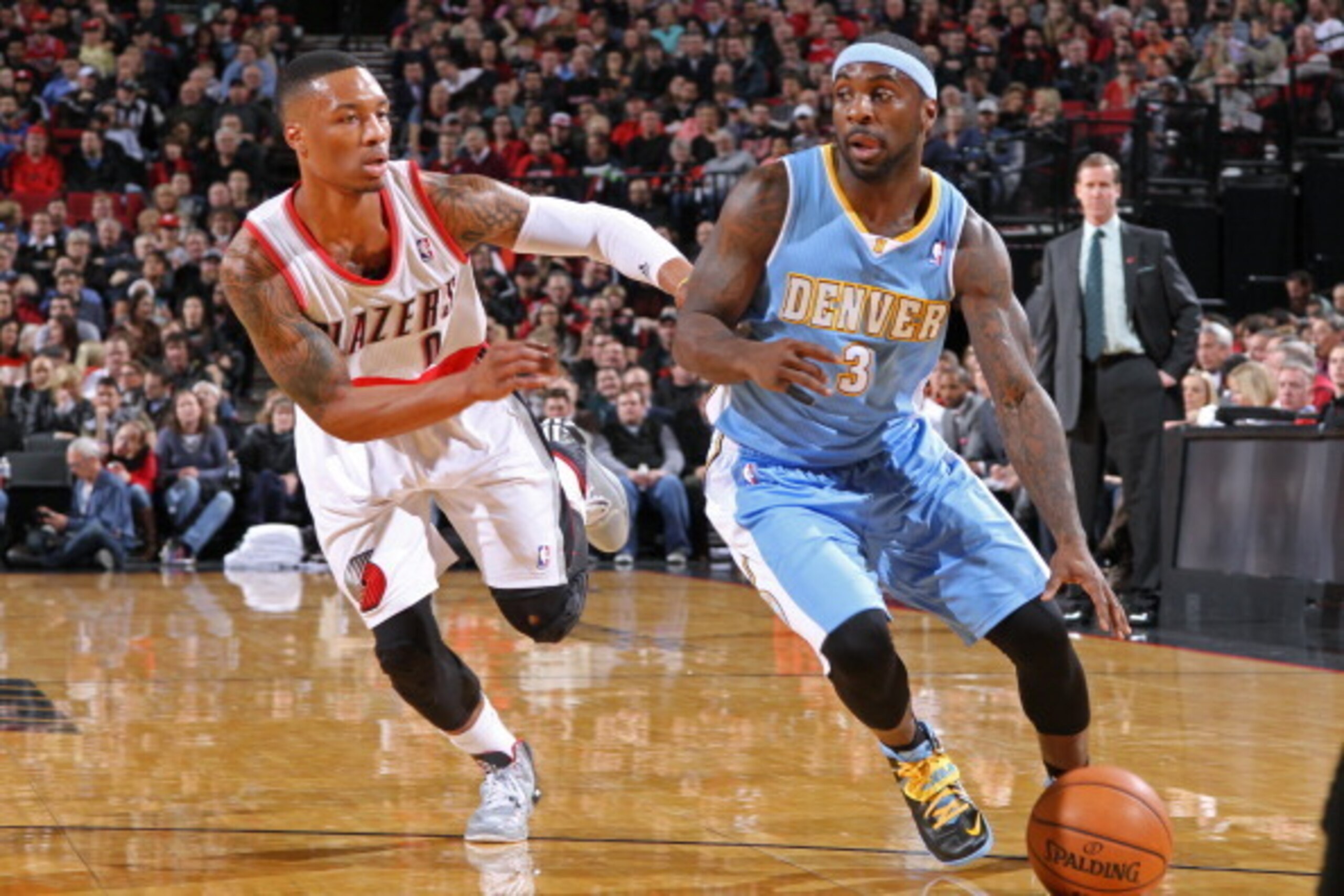 PORTLAND, OR - JANUARY 23:  Ty Lawson #3 of the Denver Nuggets drives to the basket against Damian Lillard #0 of the Portland Trail Blazers on January 23, 2014 at the Moda Center Arena in Portland, Oregon. NOTE TO USER: User expressly acknowledges and agr