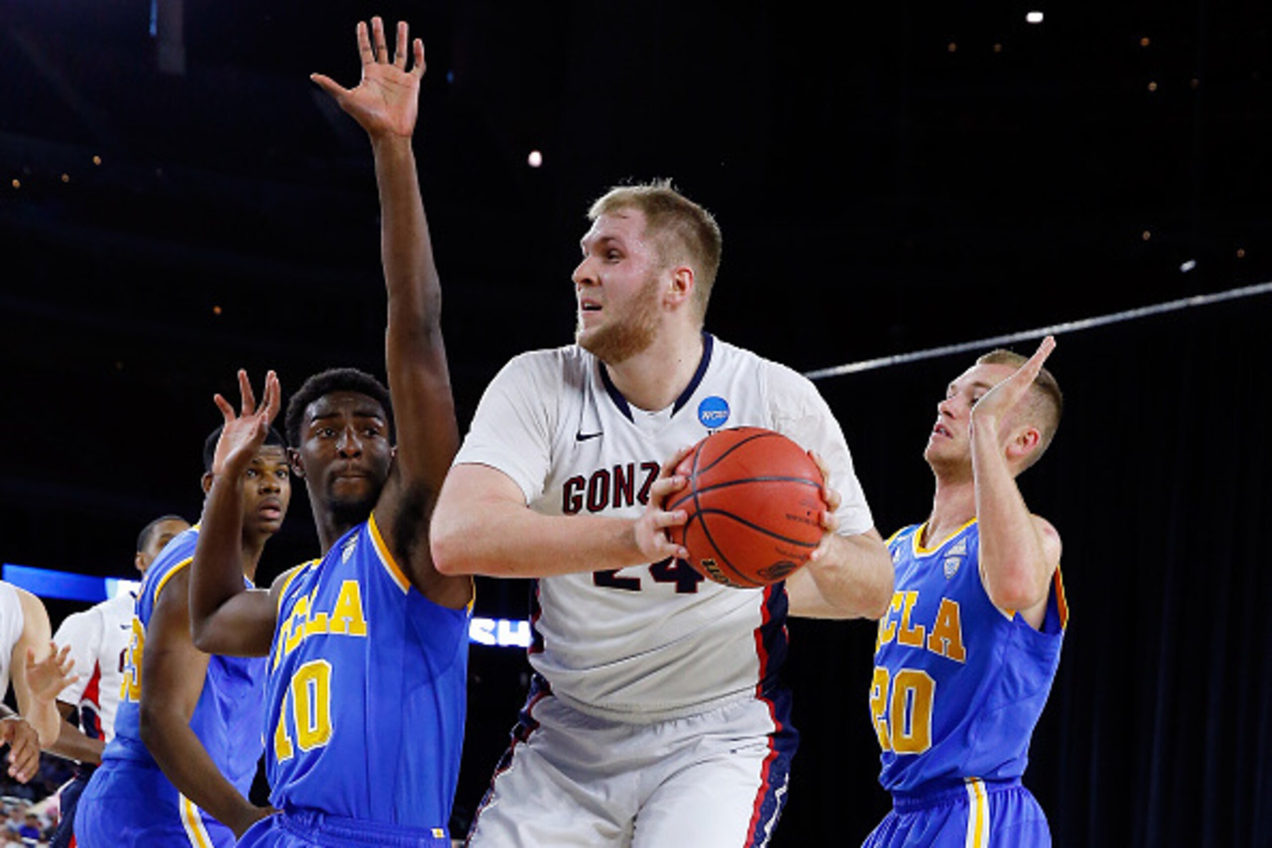HOUSTON, TX - MARCH 27: Przemek Karnowski #24 of the Gonzaga Bulldogs goes to the basket against Isaac Hamilton #10 of the UCLA Bruins during a South Regional Semifinal game of the 2015 NCAA Men's Basketball Tournament at NRG Stadium on March 27, 2015 in HOUSTON, TX - MARCH 27: Przemek Karnowski #24 of the Gonzaga Bulldogs goes to the basket against Isaac Hamilton #10 of the UCLA Bruins during a South Regional Semifinal game of the 2015 NCAA Men's Basketball Tournament at NRG Stadium on March 27, 2015 in